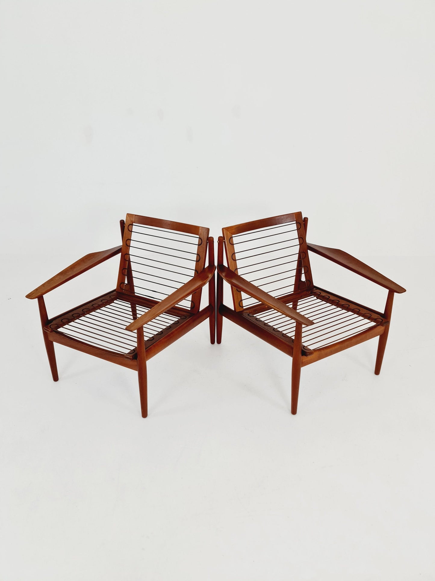 Mid century easy lounge chairs by Grete Jalk, Denmark, teak & brass, 19560s, Set of 2