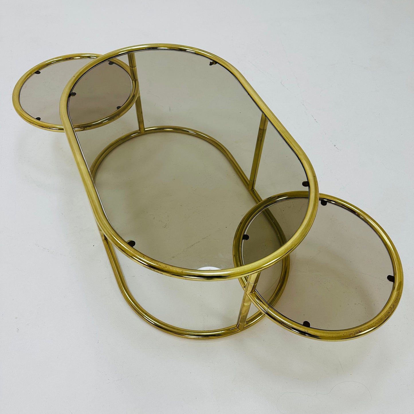 Mid century swivel coffee table brass & smoked glass ,by Milo Baughman, 1970s Italy
