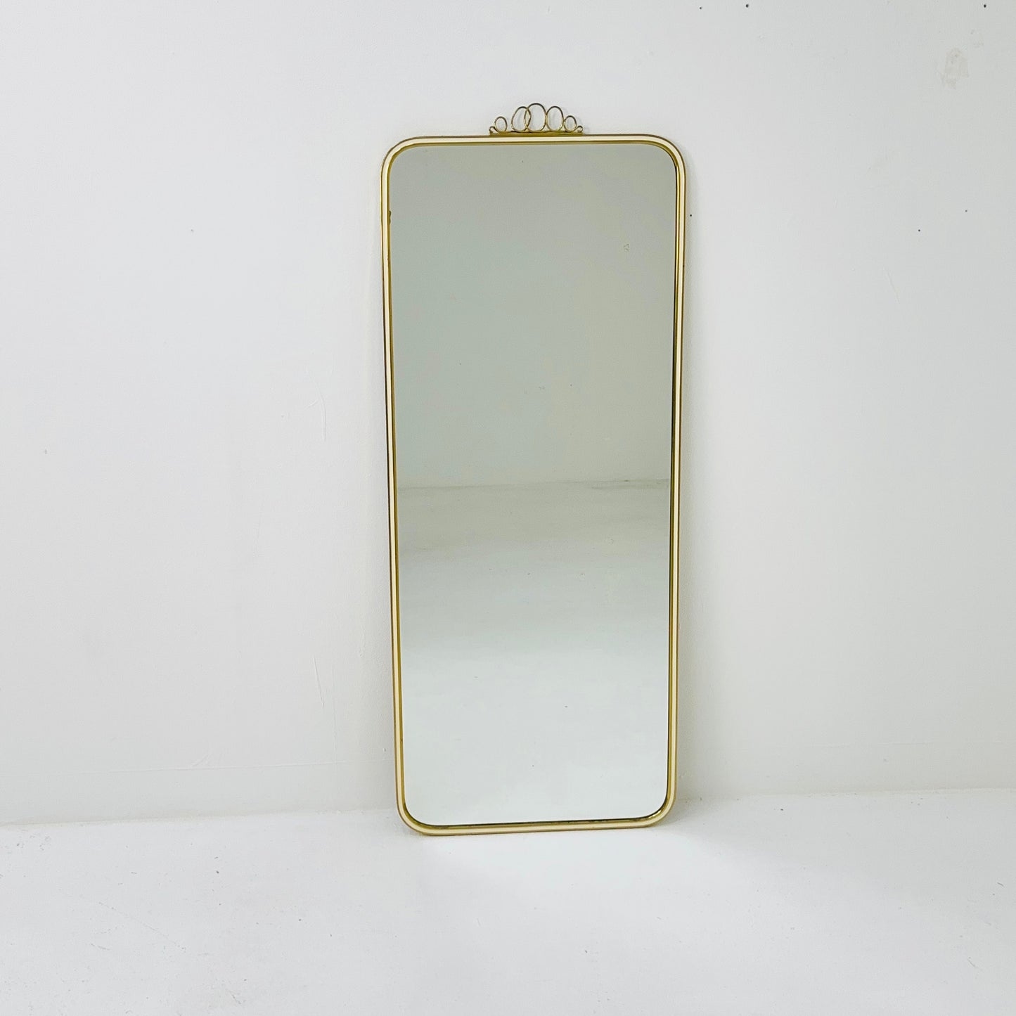 Mid century brass wall mirror with decorative bow 1950s, Italy