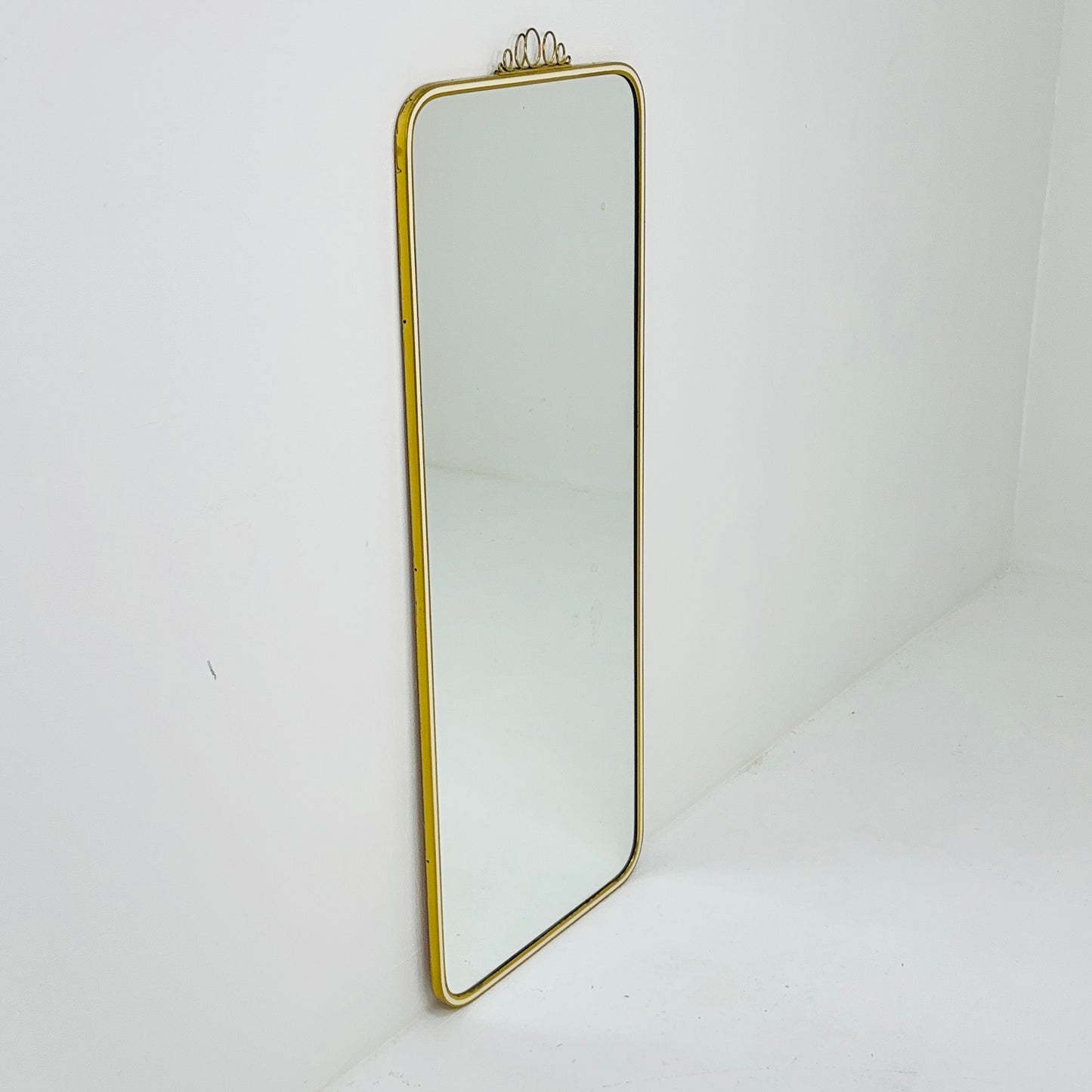 Mid century brass wall mirror with decorative bow 1950s, Italy