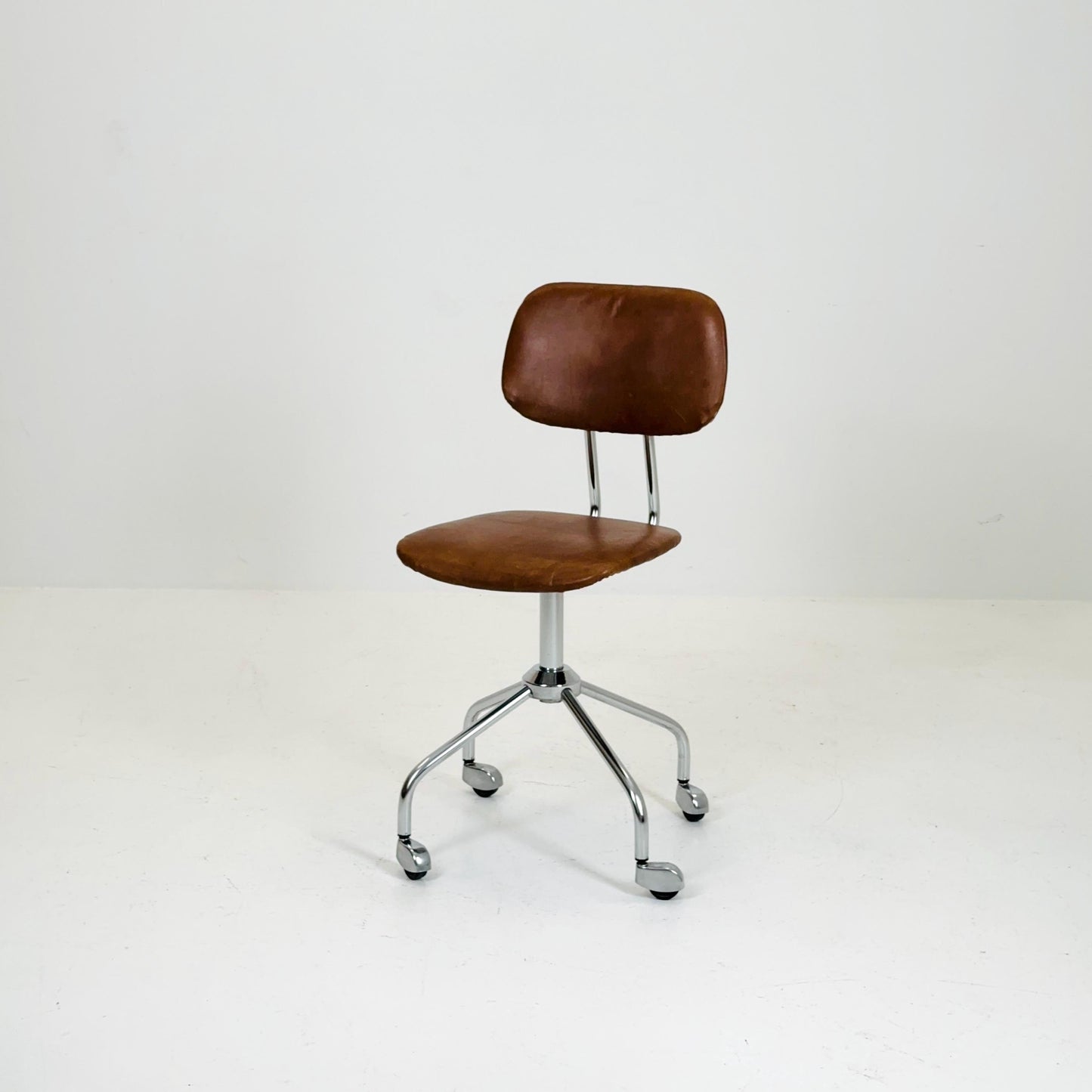 Vintage office/desk chair in brown leather with swivel steel structure Italy 1960s