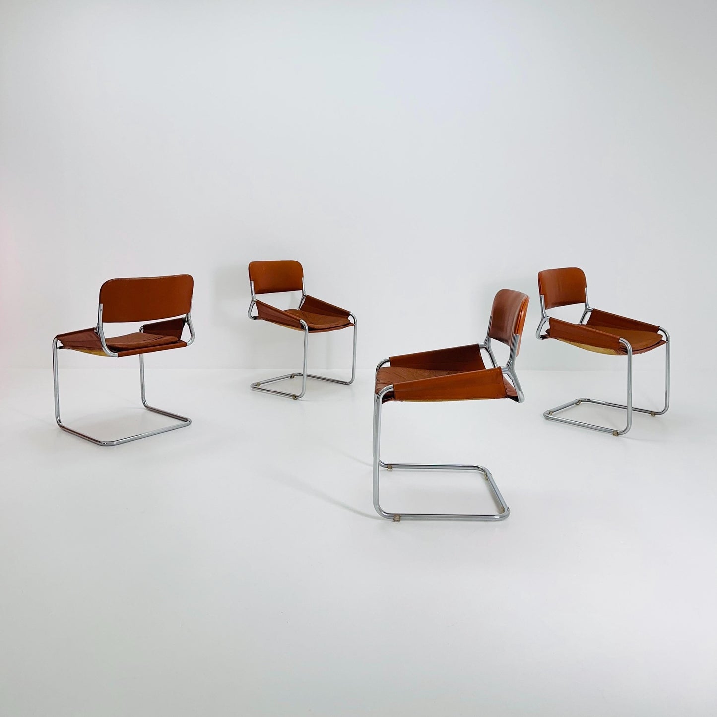 Set of 4 Mid century cognac leather & chrome tubular sling chair, Italy 1970
