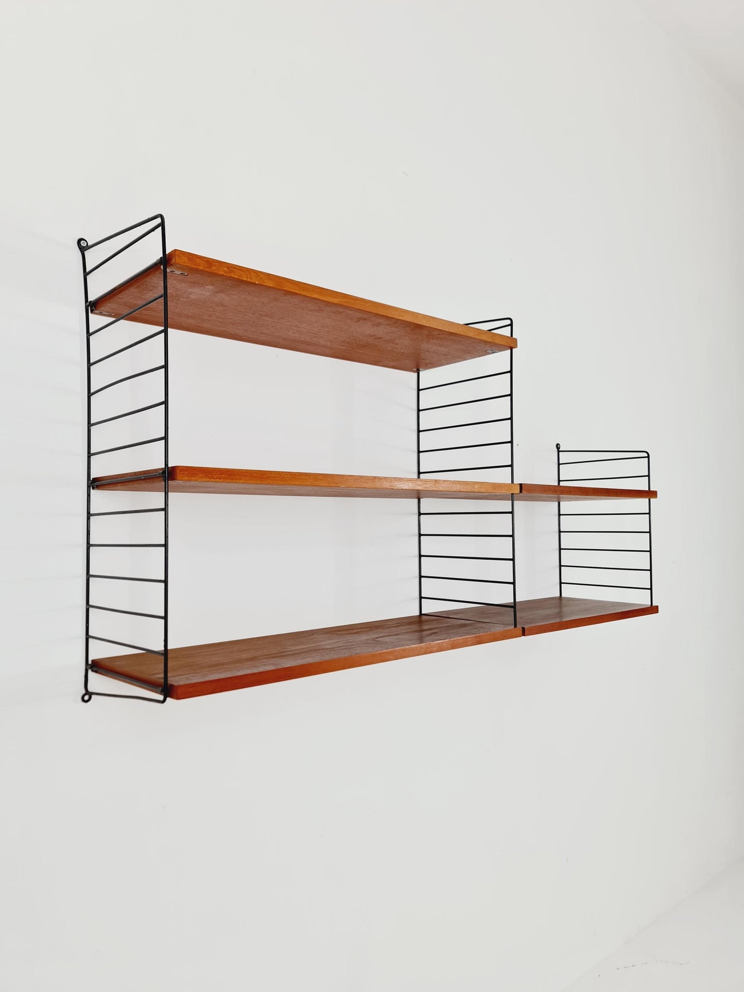 Original MCM Teak shelving system - consists of Black lacquered metal ladders, from string Stockholm 1960s