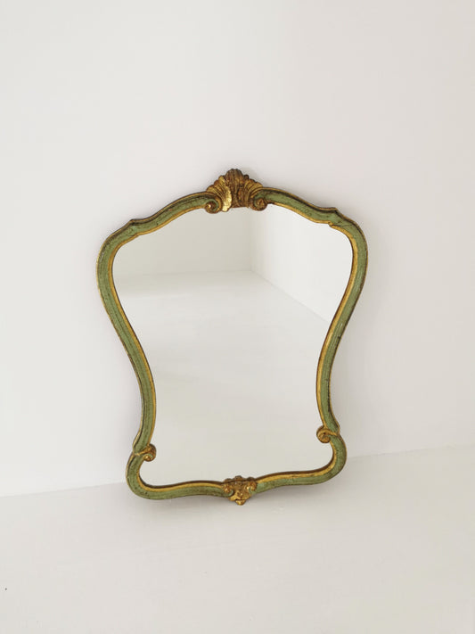 Classic style mirror in gold leaf with shaped frame Italy 1980s.