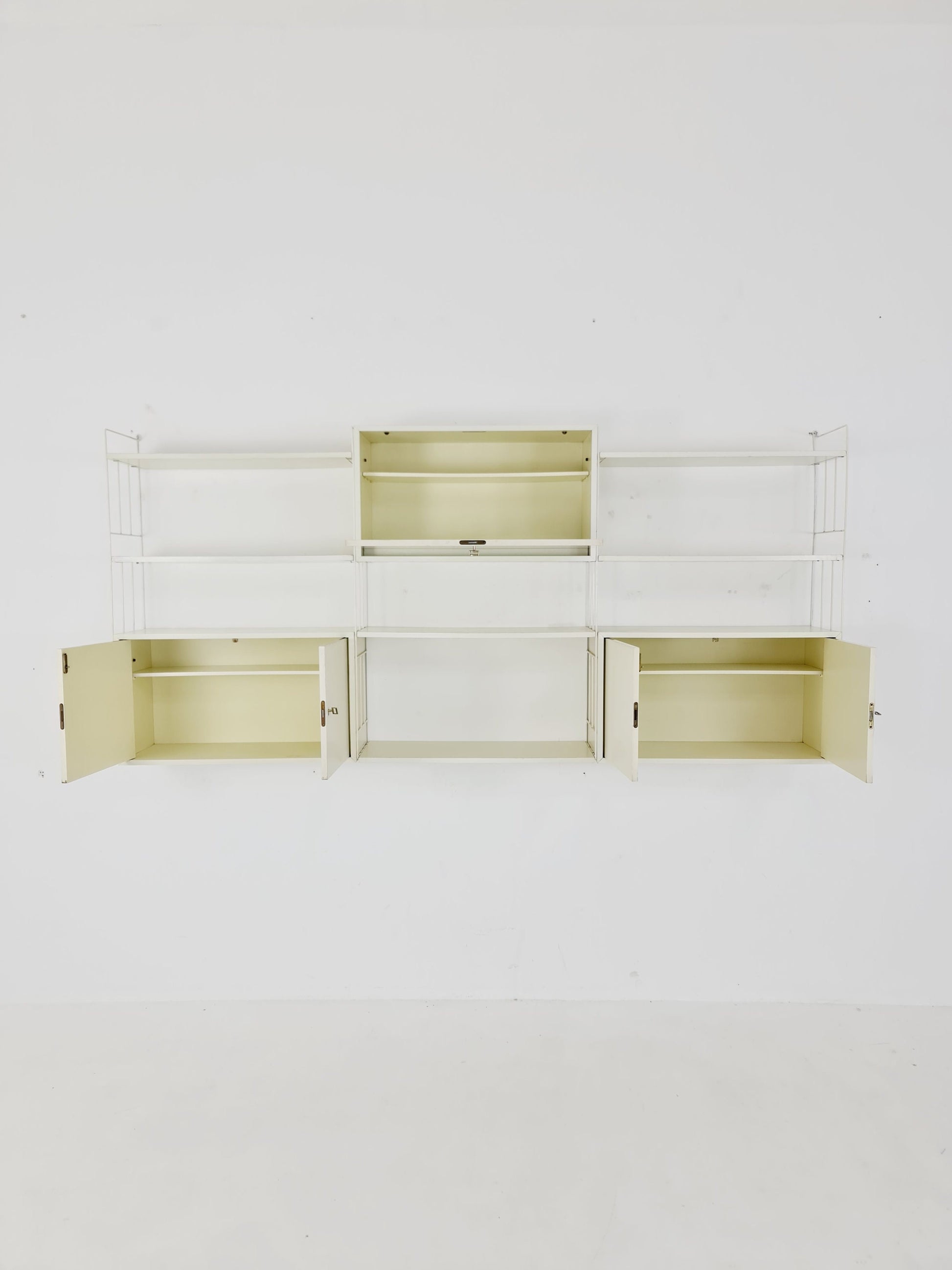 Wall-hanging String shelf-system, bookcase with bar cabinetby WHB Germany, 1950s