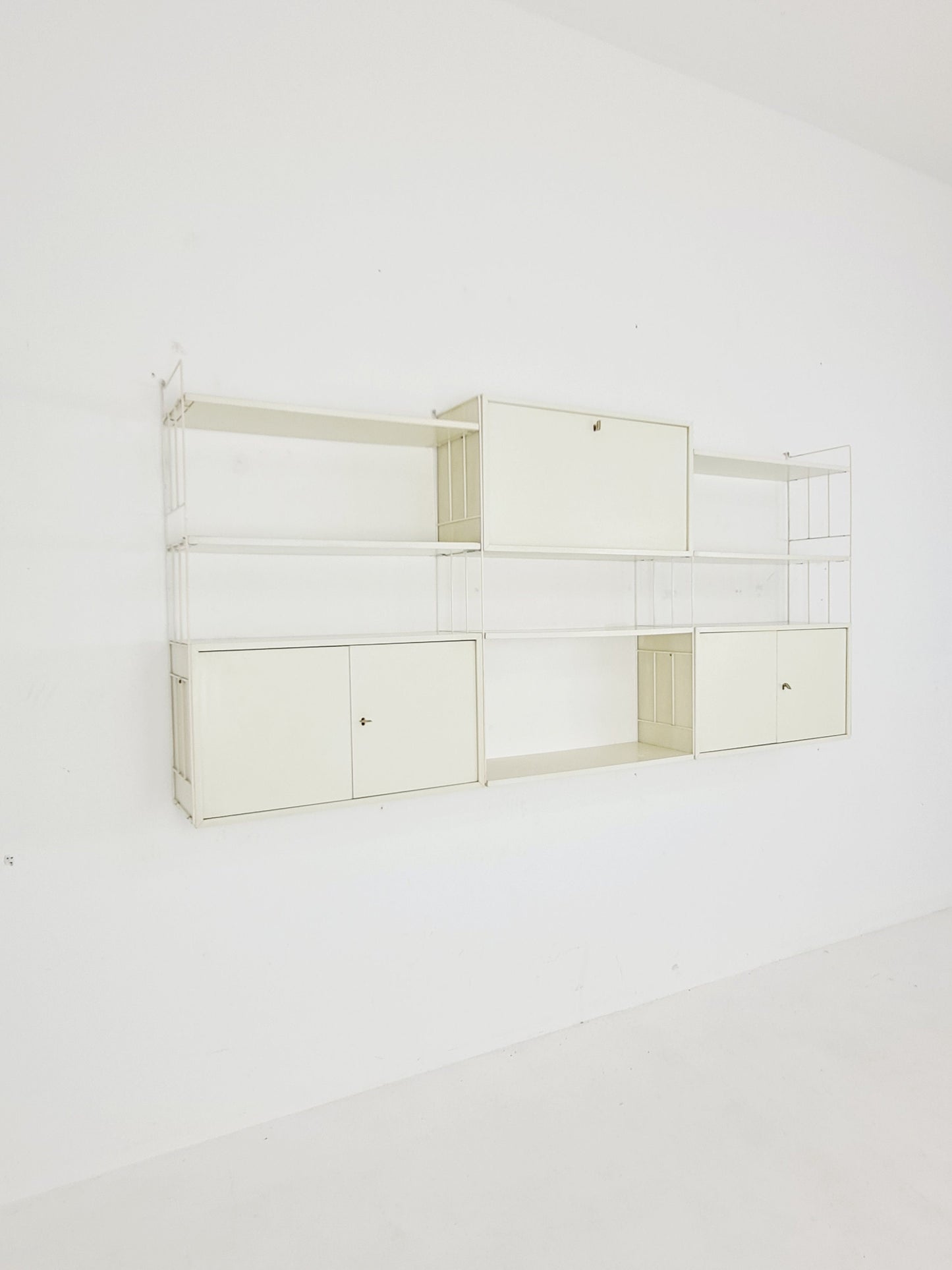 Wall-hanging String shelf-system, bookcase with bar cabinetby WHB Germany, 1950s