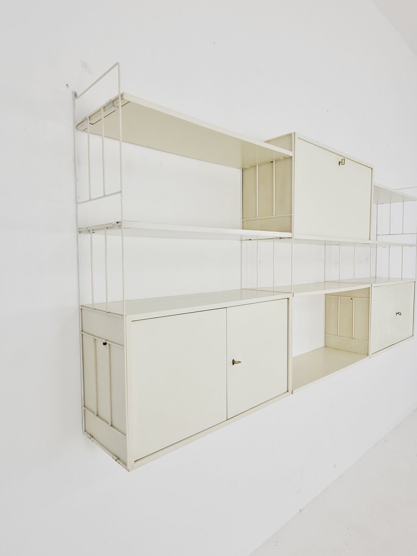 Wall-hanging String shelf-system, bookcase with bar cabinetby WHB Germany, 1950s