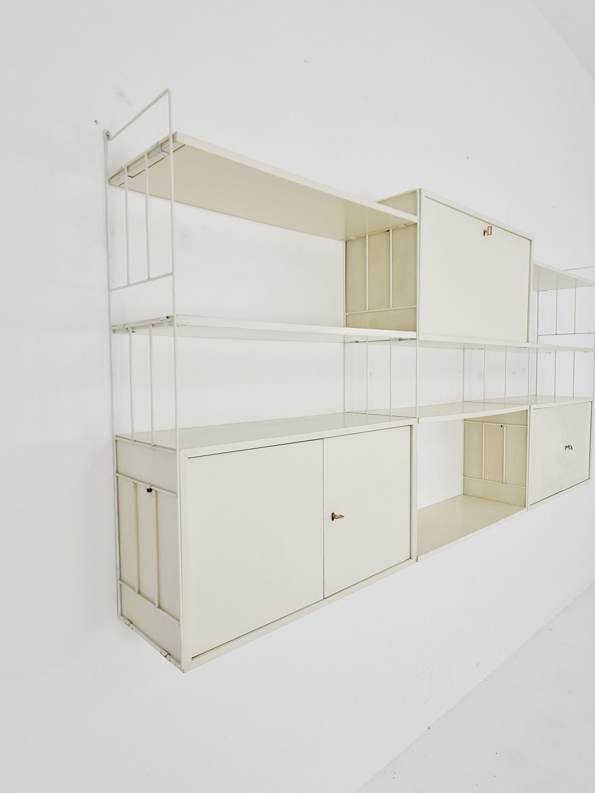 Wall-hanging String shelf-system, bookcase with bar cabinetby WHB Germany, 1950s