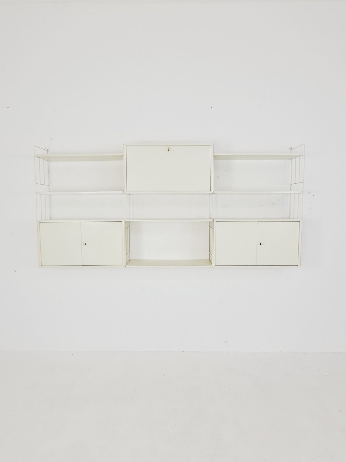Wall-hanging String shelf-system, bookcase with bar cabinetby WHB Germany, 1950s