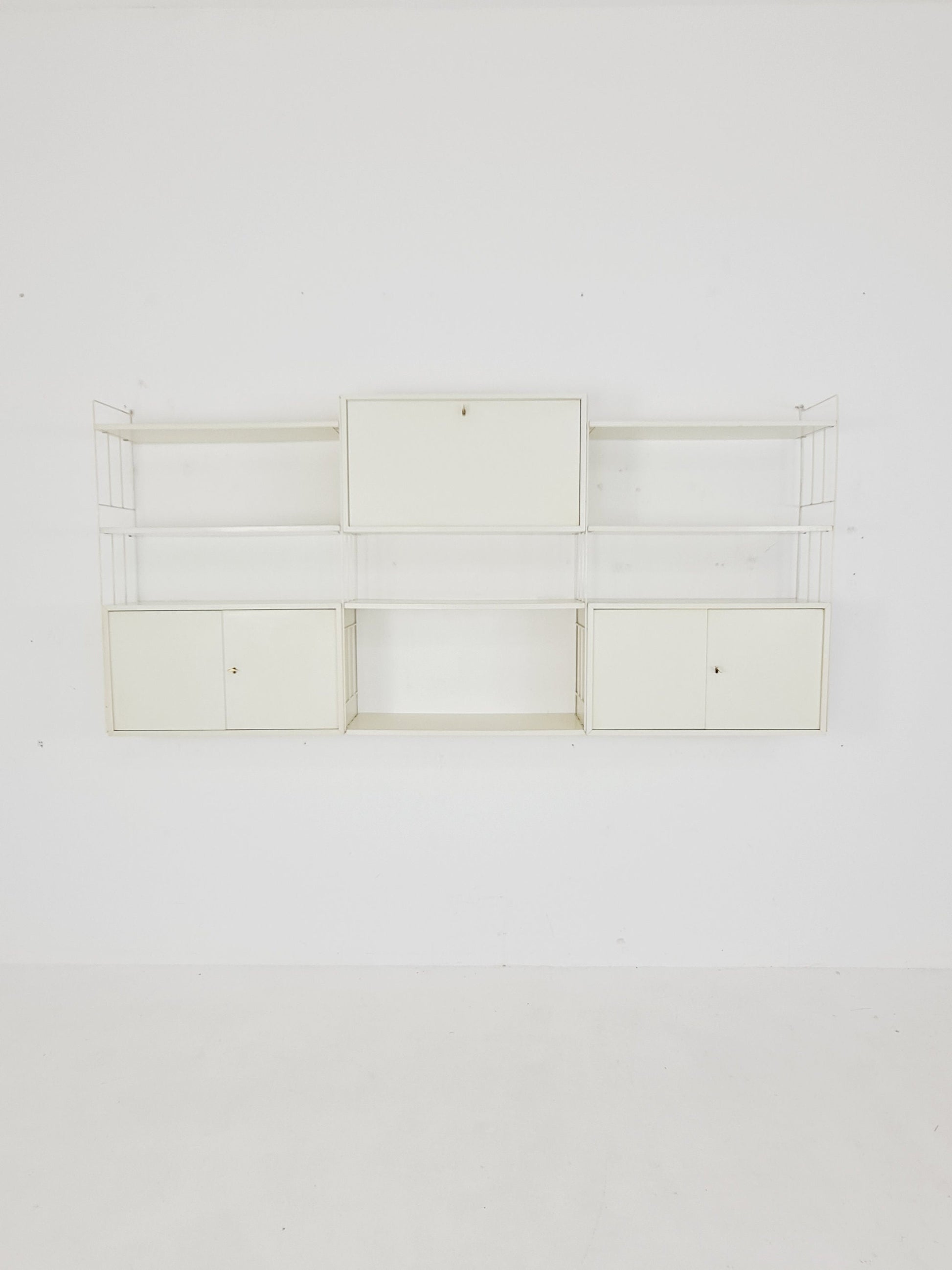 Wall-hanging String shelf-system, bookcase with bar cabinetby WHB Germany, 1950s