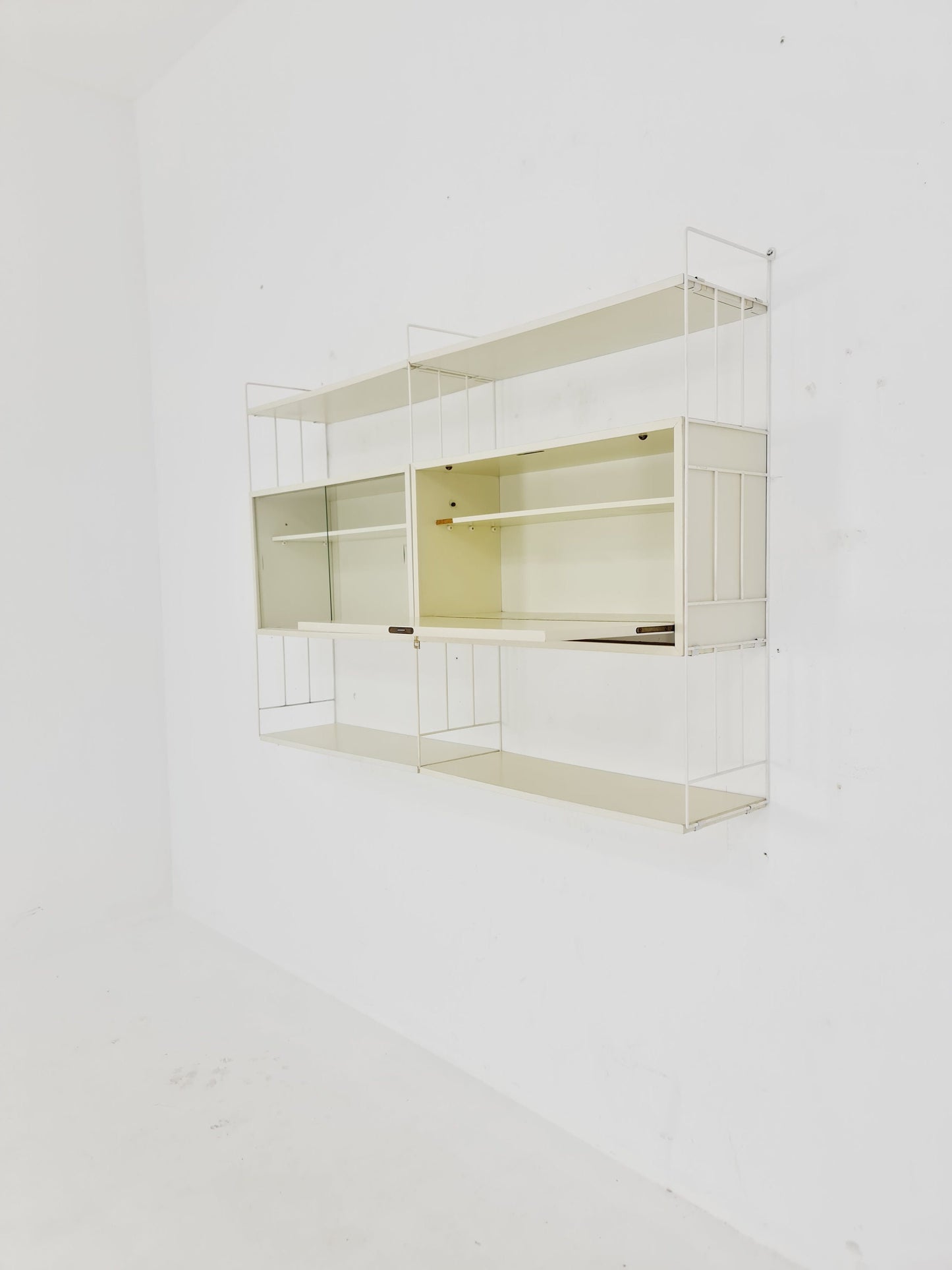 Wall-hanging String shelf-system, bookcase with bar cabinet by WHB Germany, 1950s