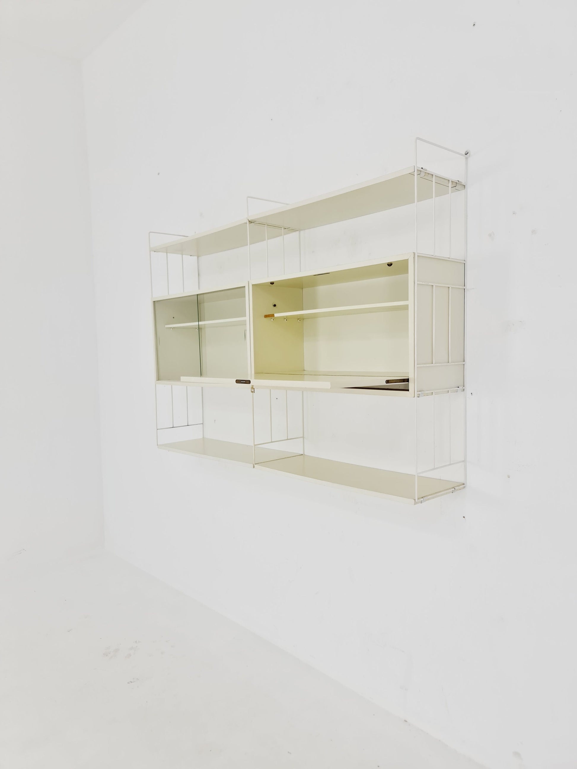Wall-hanging String shelf-system, bookcase with bar cabinet by WHB Germany, 1950s