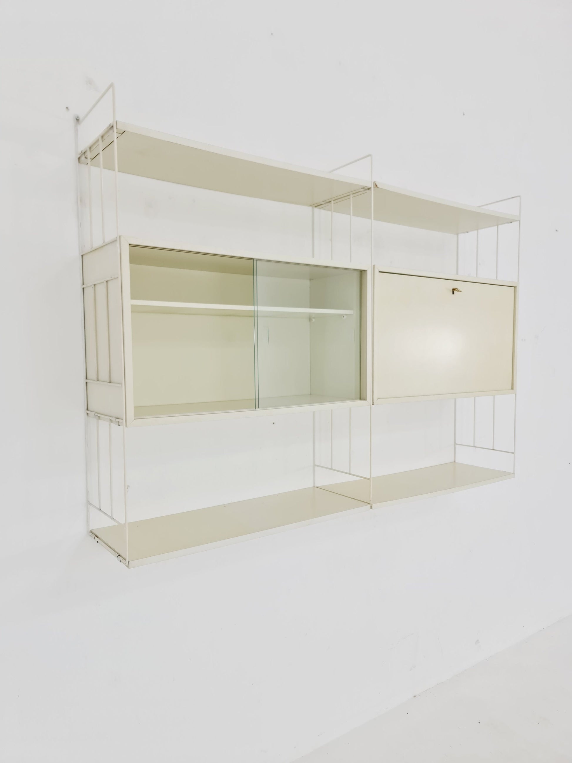 Wall-hanging String shelf-system, bookcase with bar cabinet by WHB Germany, 1950s
