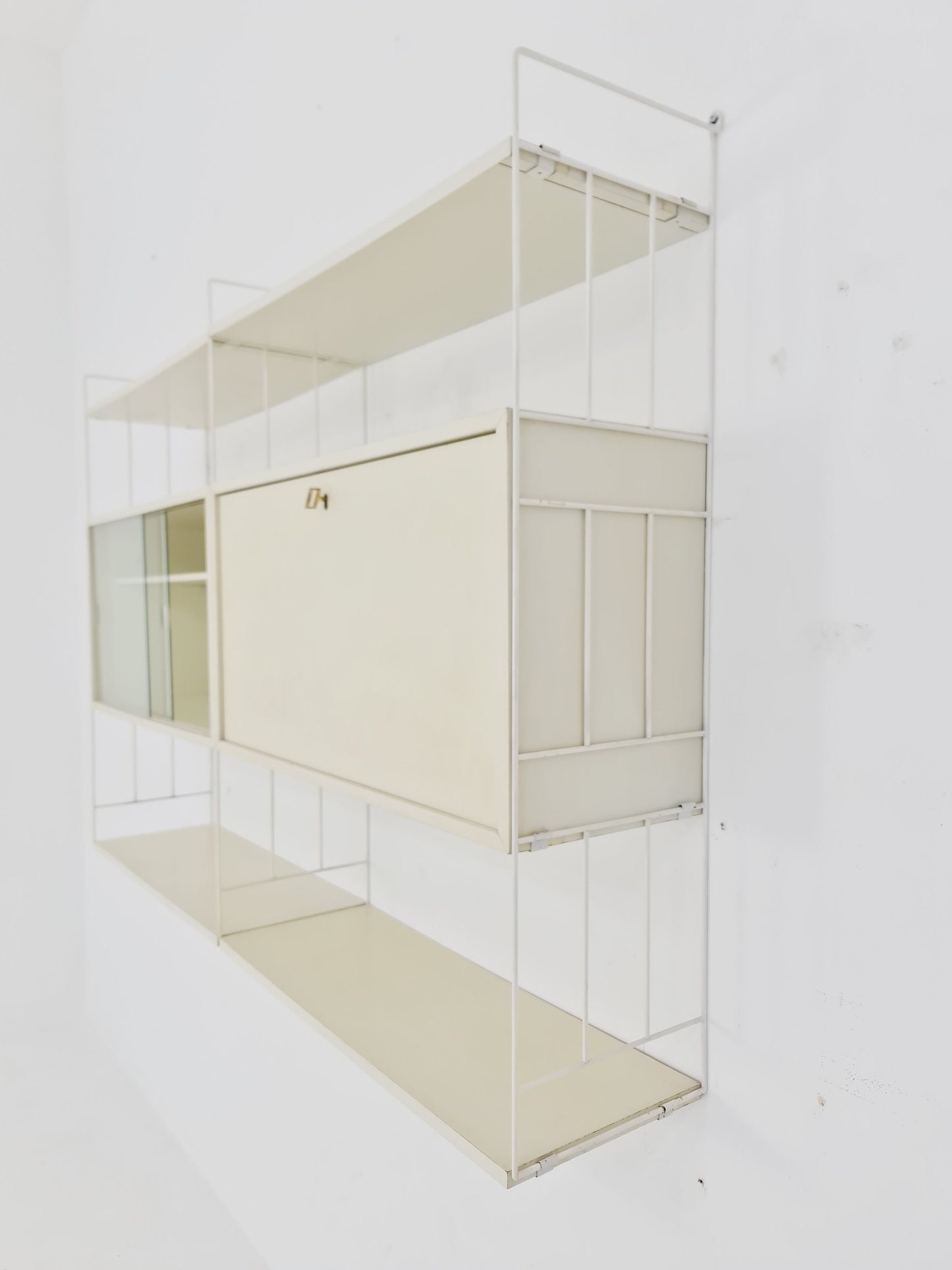 Wall-hanging String shelf-system, bookcase with bar cabinet by WHB Germany, 1950s