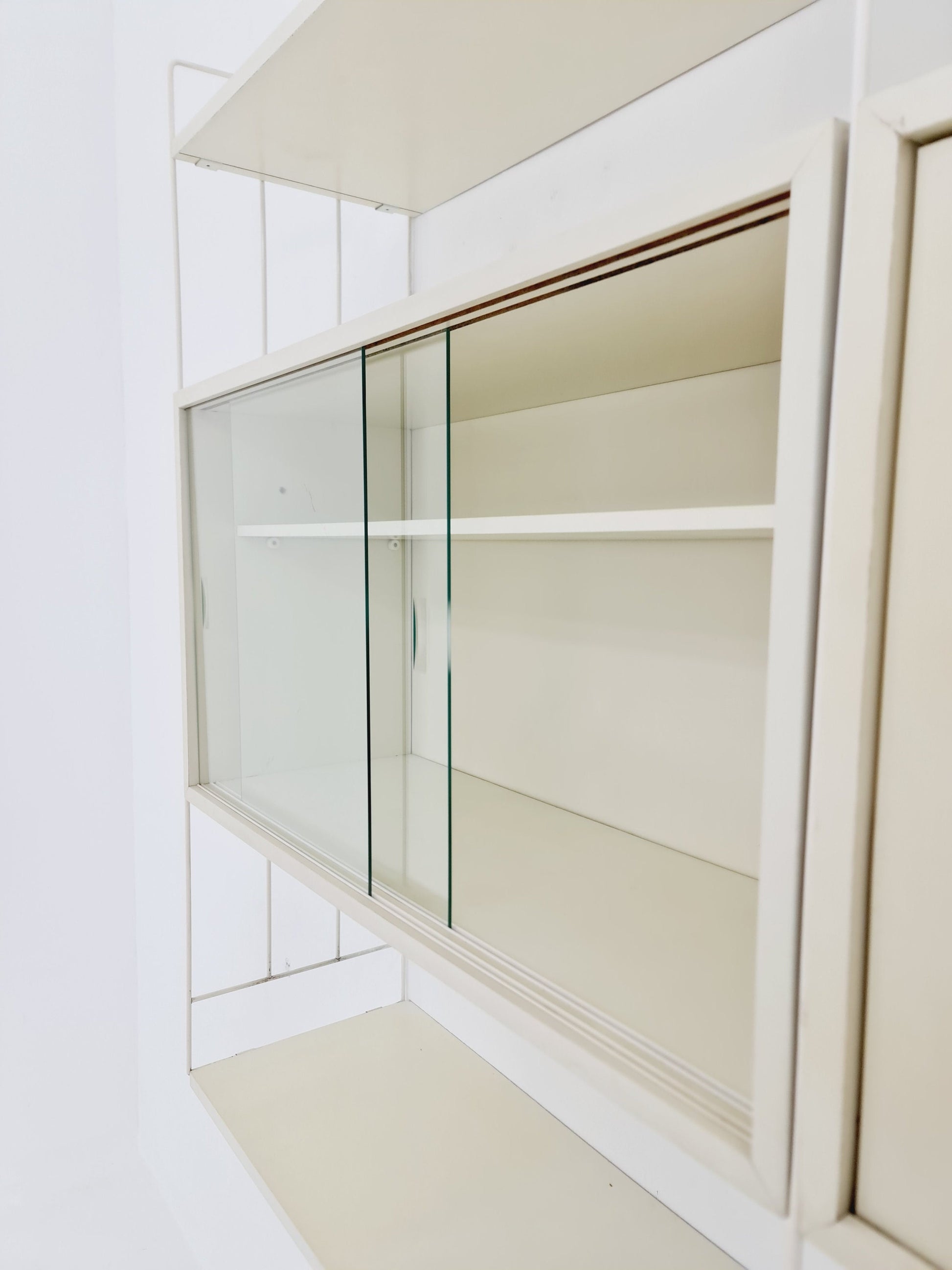 Wall-hanging String shelf-system, bookcase with bar cabinet by WHB Germany, 1950s