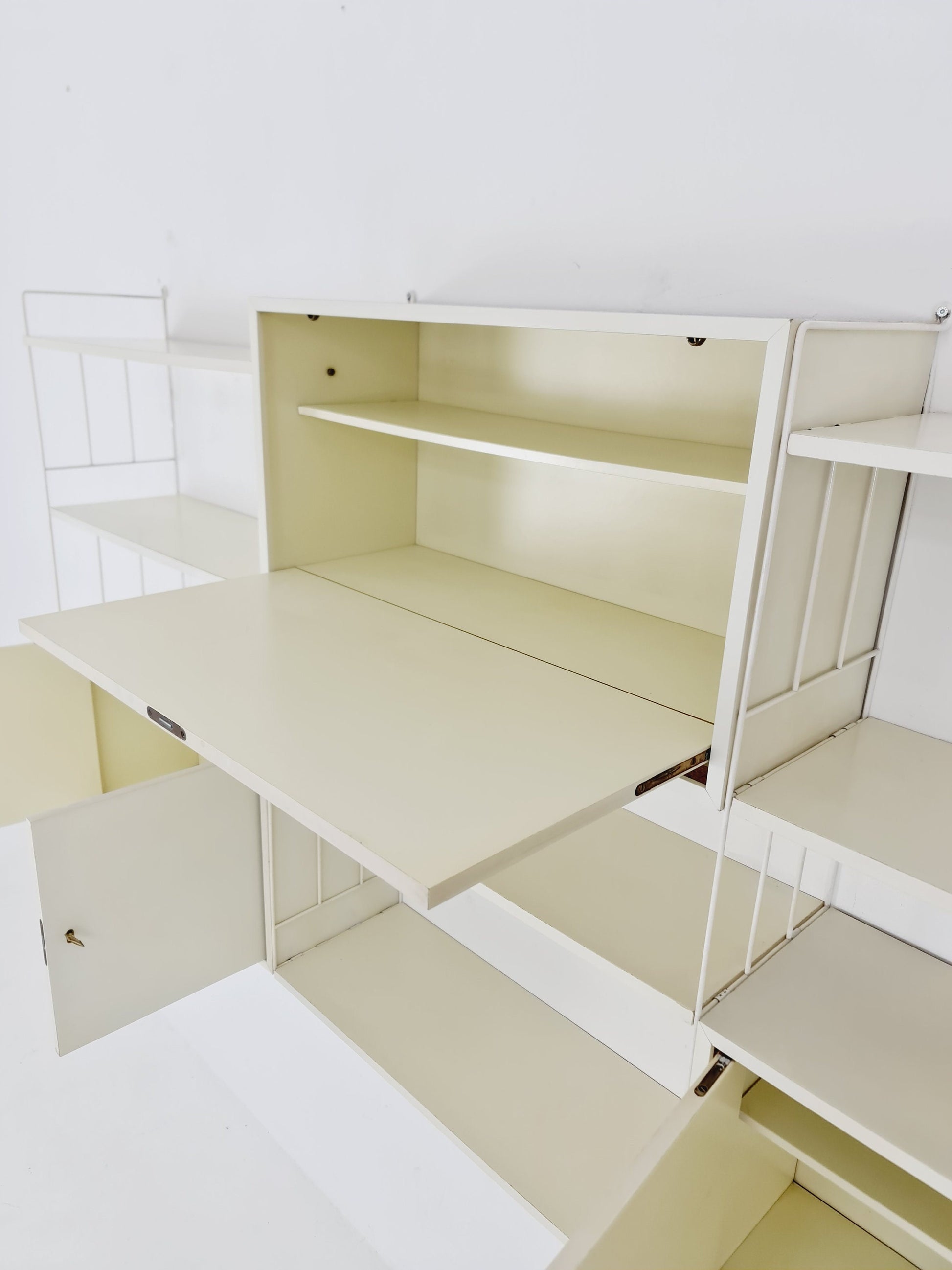 Wall-hanging String shelf-system, bookcase with bar cabinetby WHB Germany, 1950s