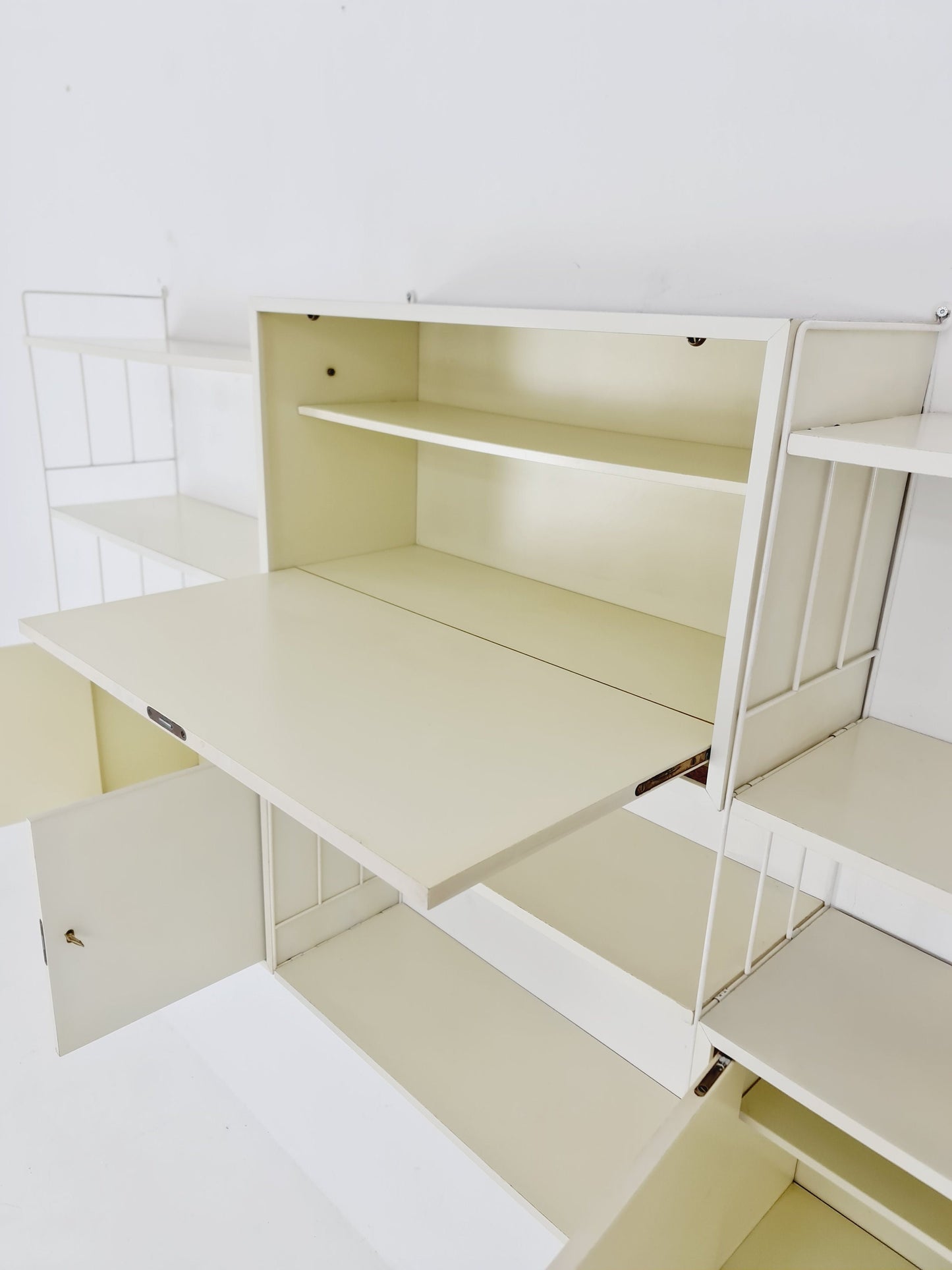 Wall-hanging String shelf-system, bookcase with bar cabinetby WHB Germany, 1950s