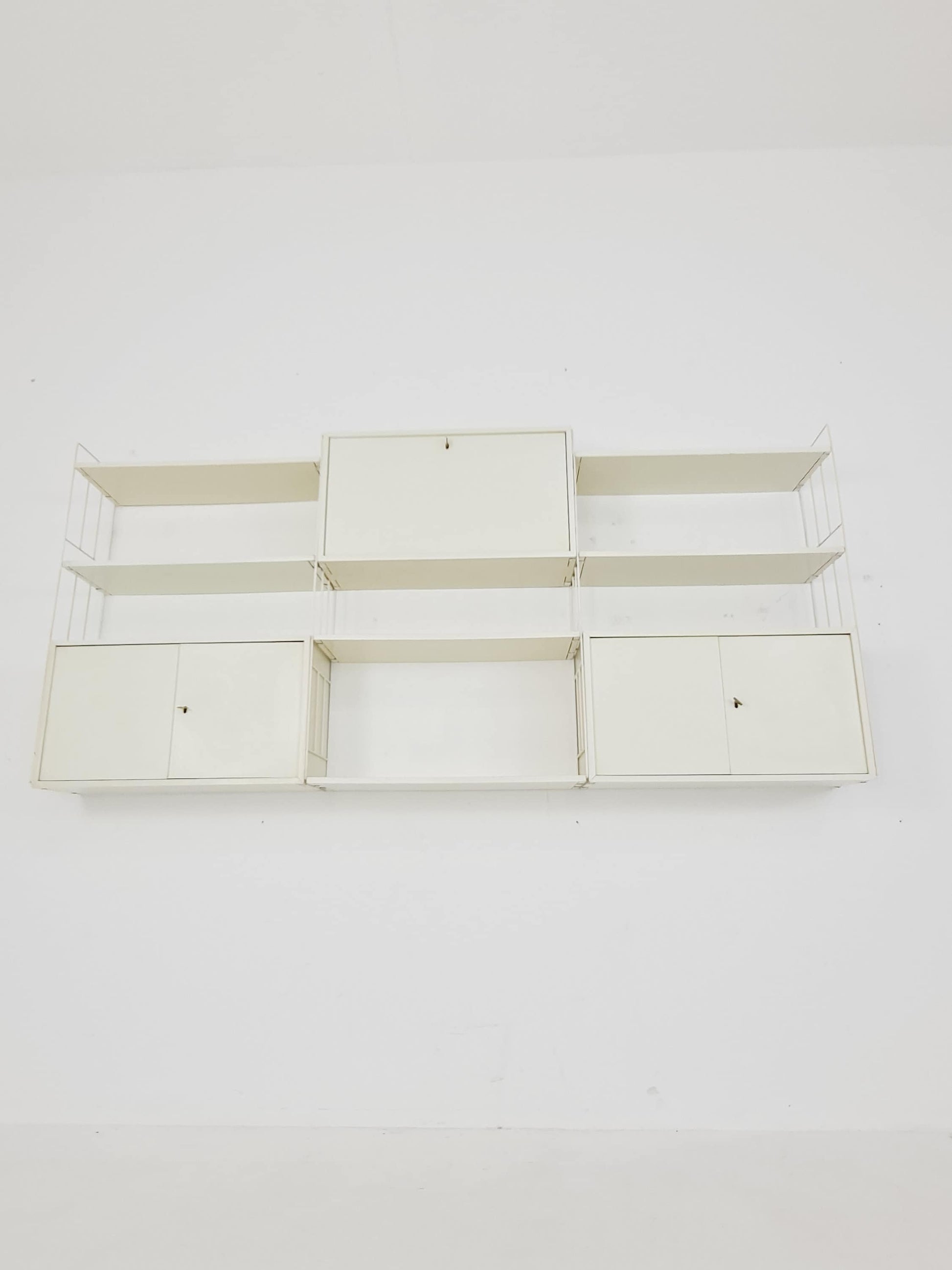 Wall-hanging String shelf-system, bookcase with bar cabinetby WHB Germany, 1950s