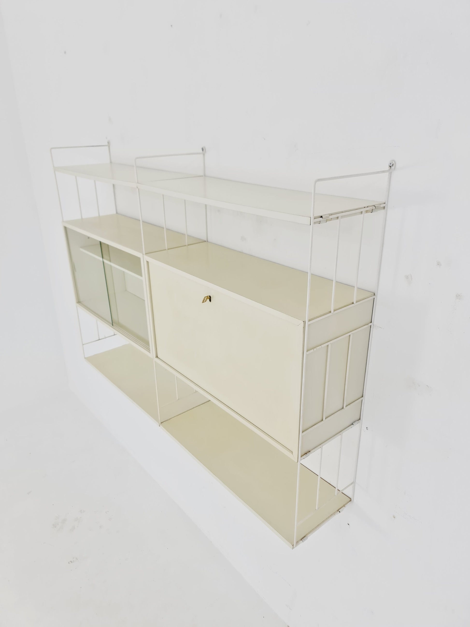 Wall-hanging String shelf-system, bookcase with bar cabinet by WHB Germany, 1950s