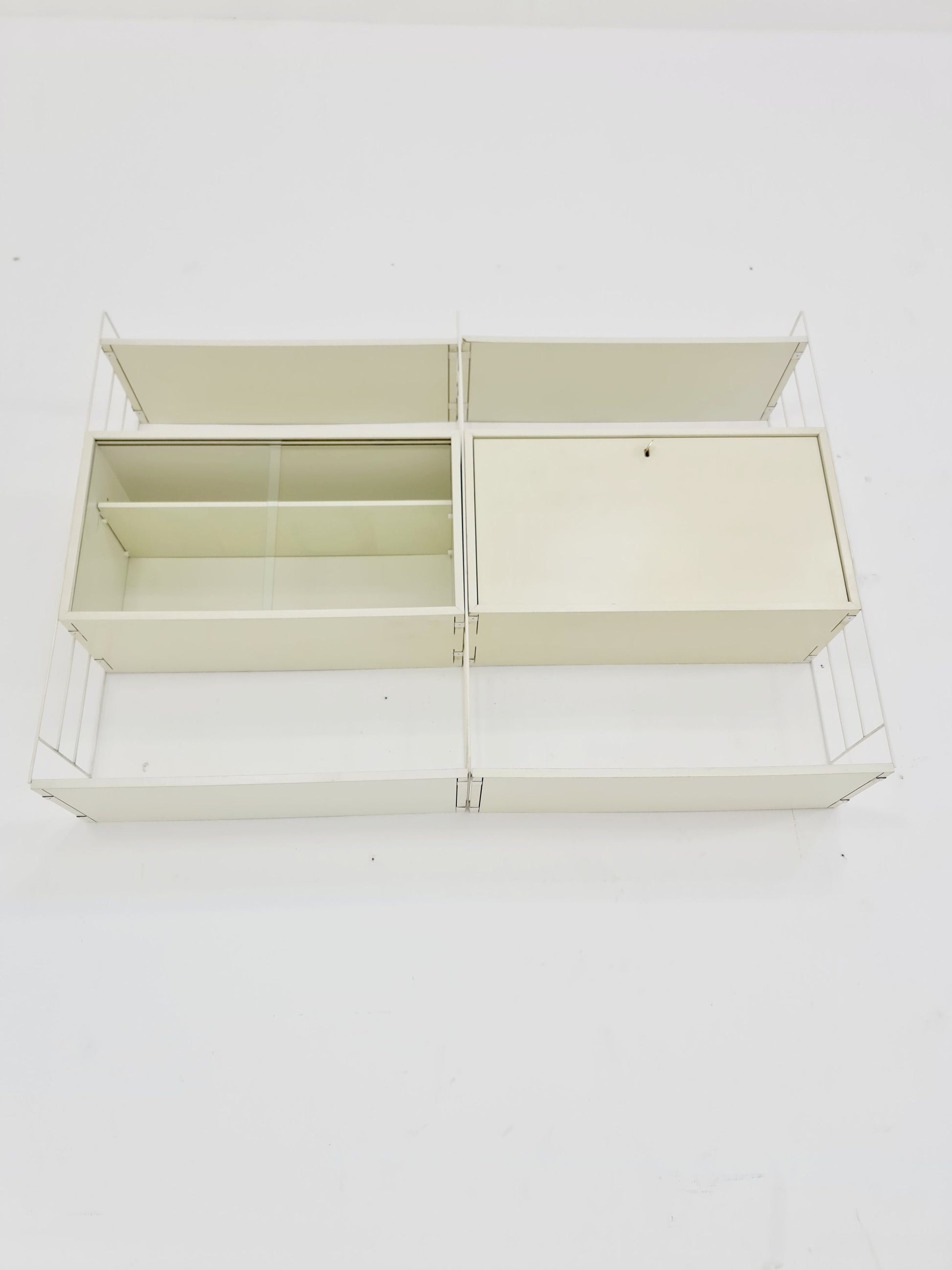 Wall-hanging String shelf-system, bookcase with bar cabinet by WHB Germany, 1950s