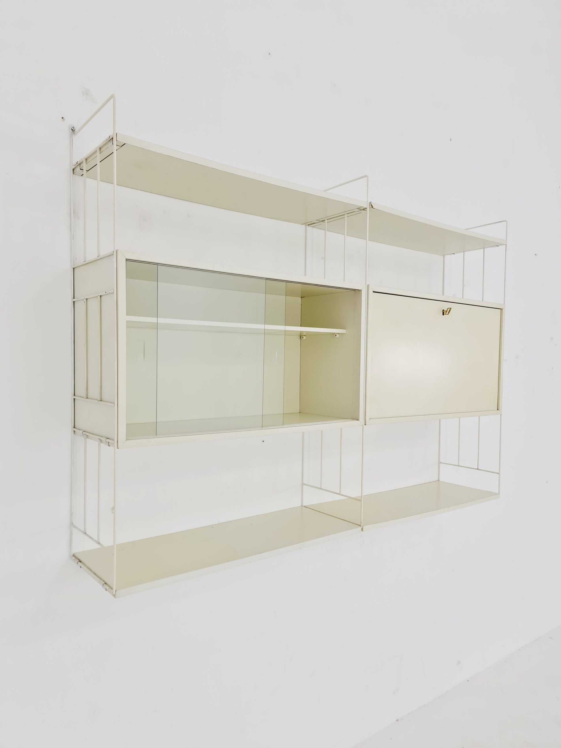 Wall-hanging String shelf-system, bookcase with bar cabinet by WHB Germany, 1950s