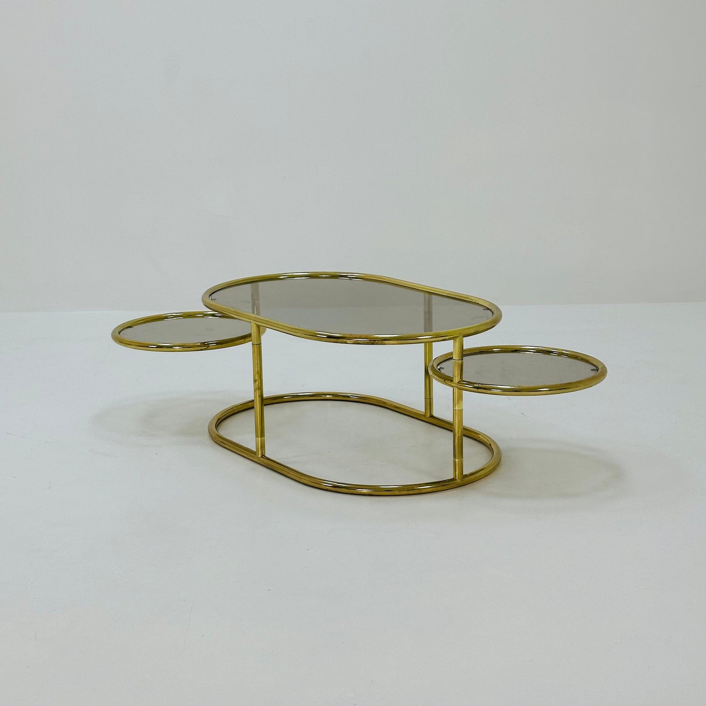 Mid century swivel coffee table brass & smoked glass ,by Milo Baughman, 1970s Italy 