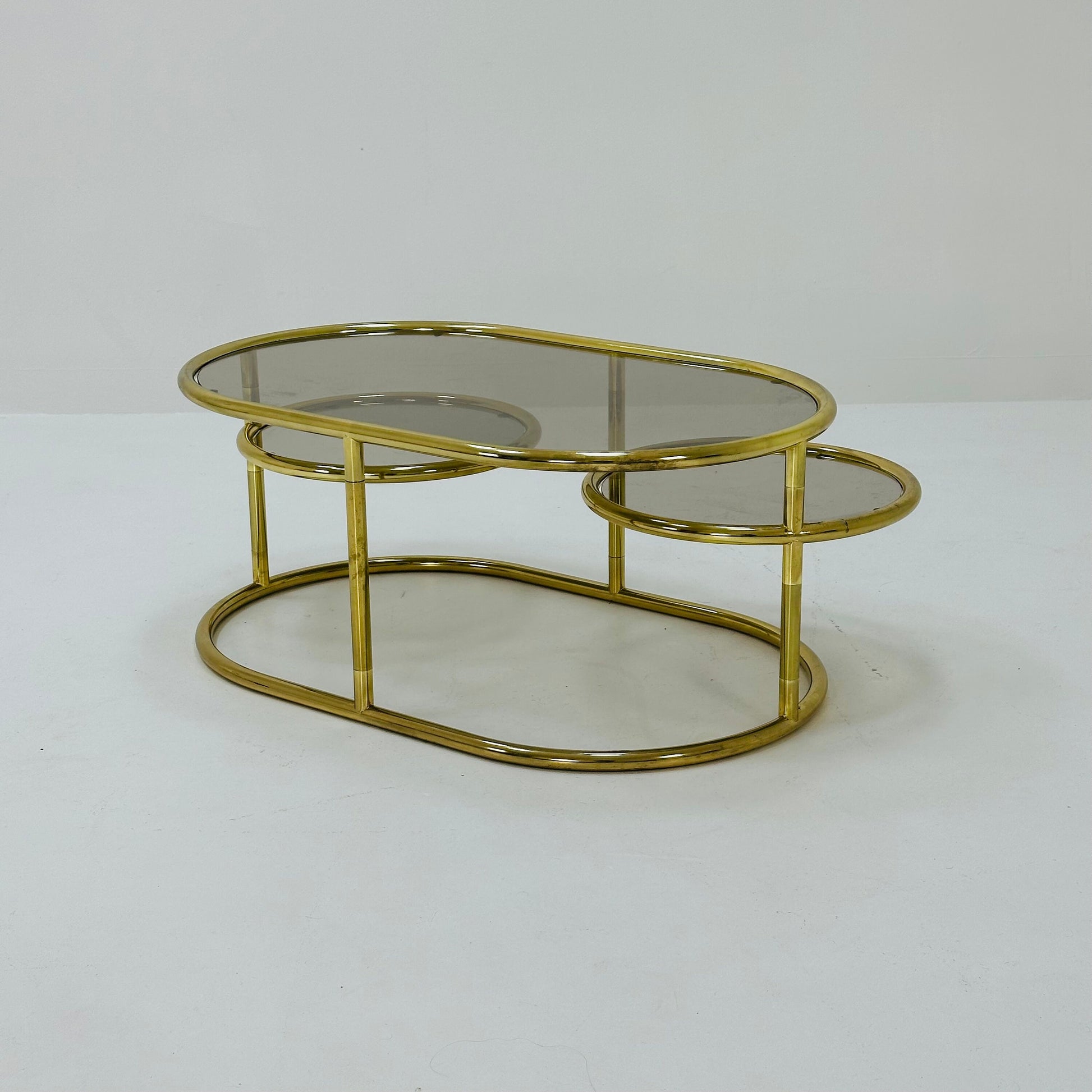 Mid century swivel coffee table brass & smoked glass ,by Milo Baughman, 1970s Italy 