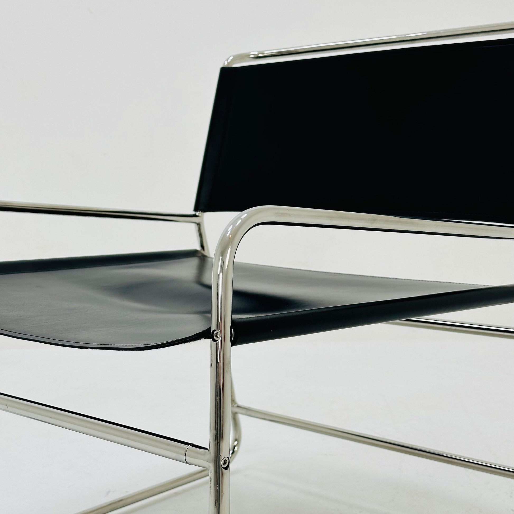 Mid century black leather lounge chair in Bauhaus style .