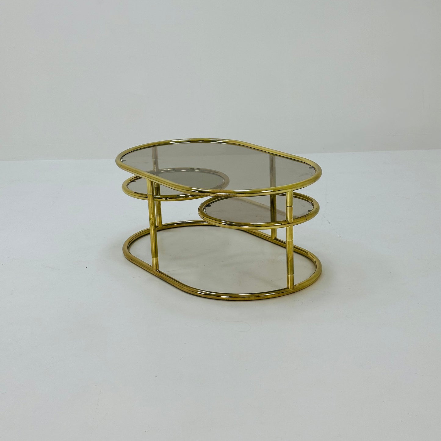 Mid century swivel coffee table brass & smoked glass ,by Milo Baughman, 1970s Italy 