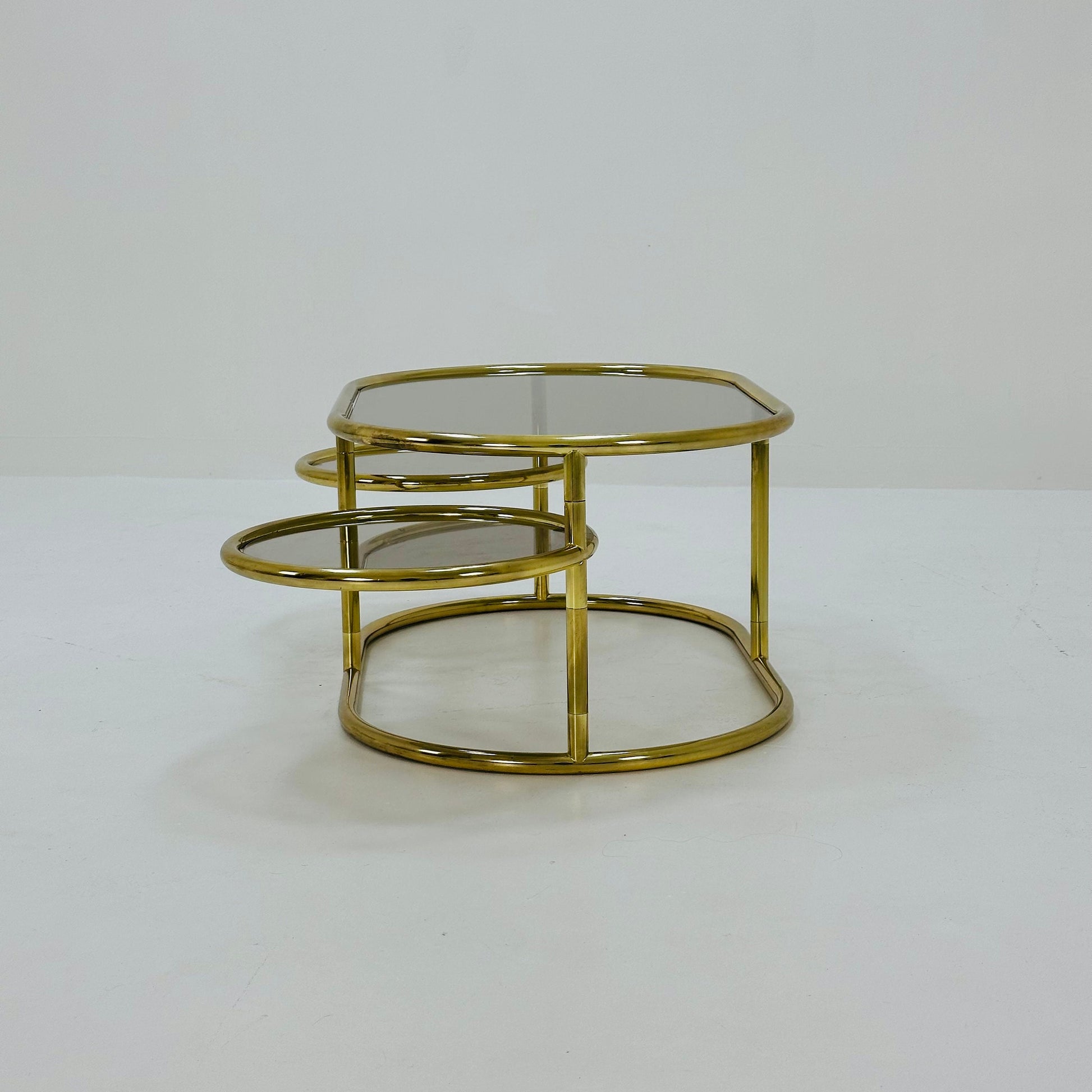 Mid century swivel coffee table brass & smoked glass ,by Milo Baughman, 1970s Italy 