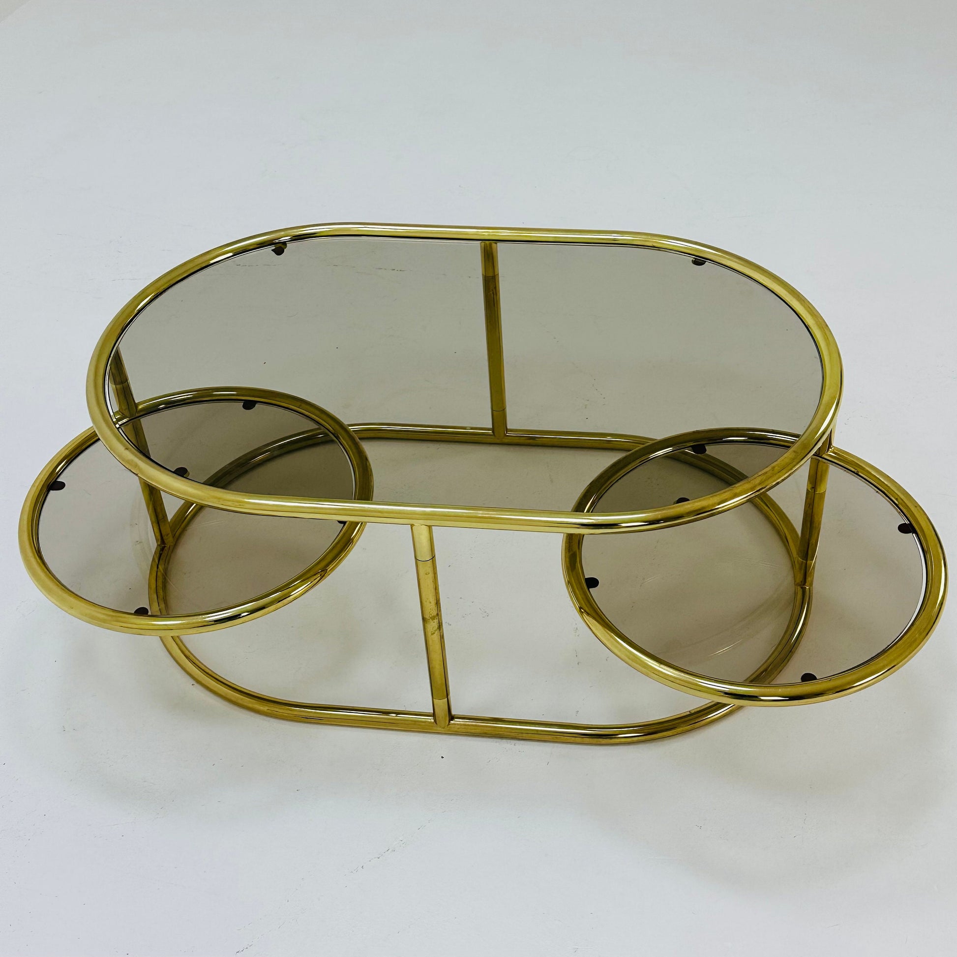 Mid century swivel coffee table brass & smoked glass ,by Milo Baughman, 1970s Italy