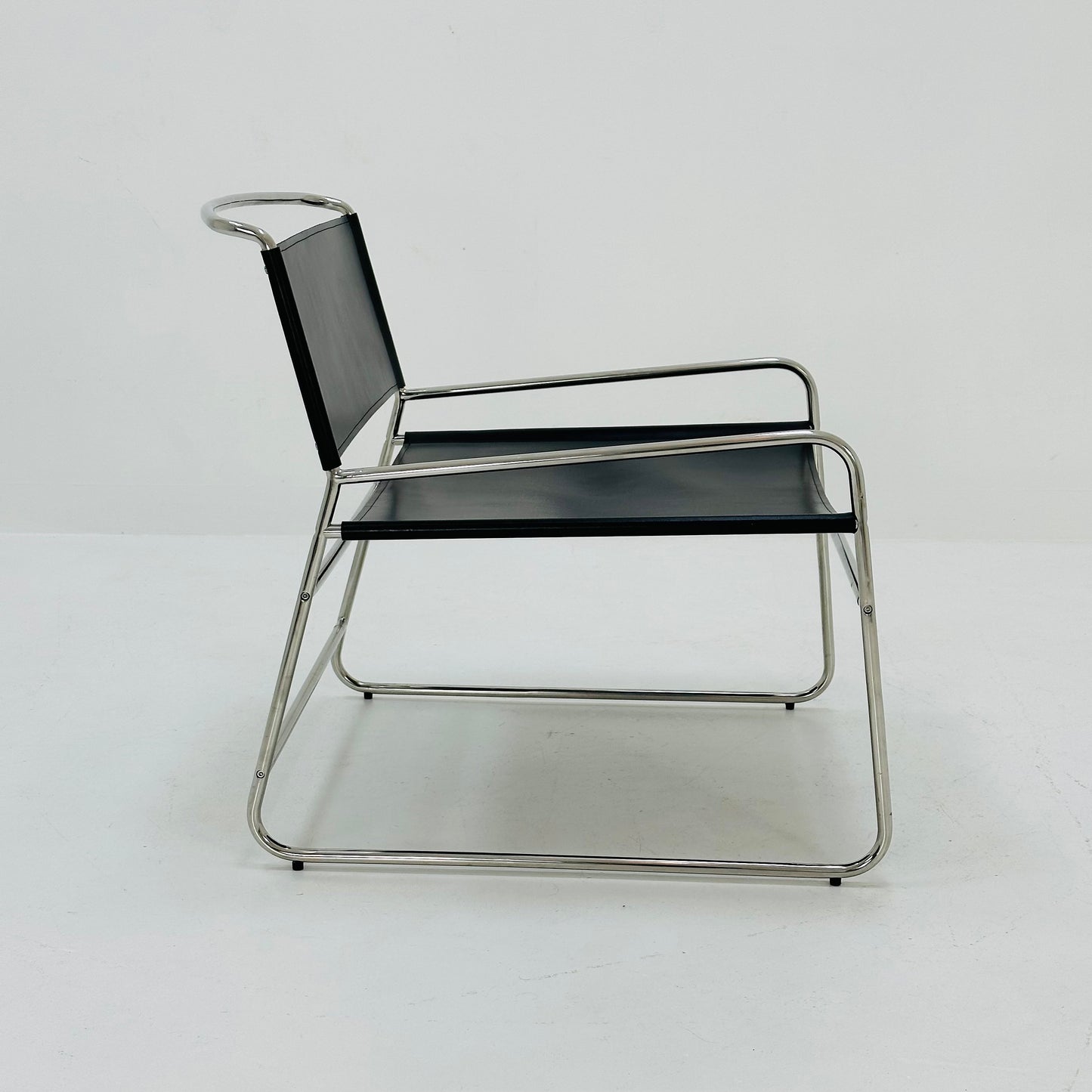 Mid century black leather lounge chair in Bauhaus style .
