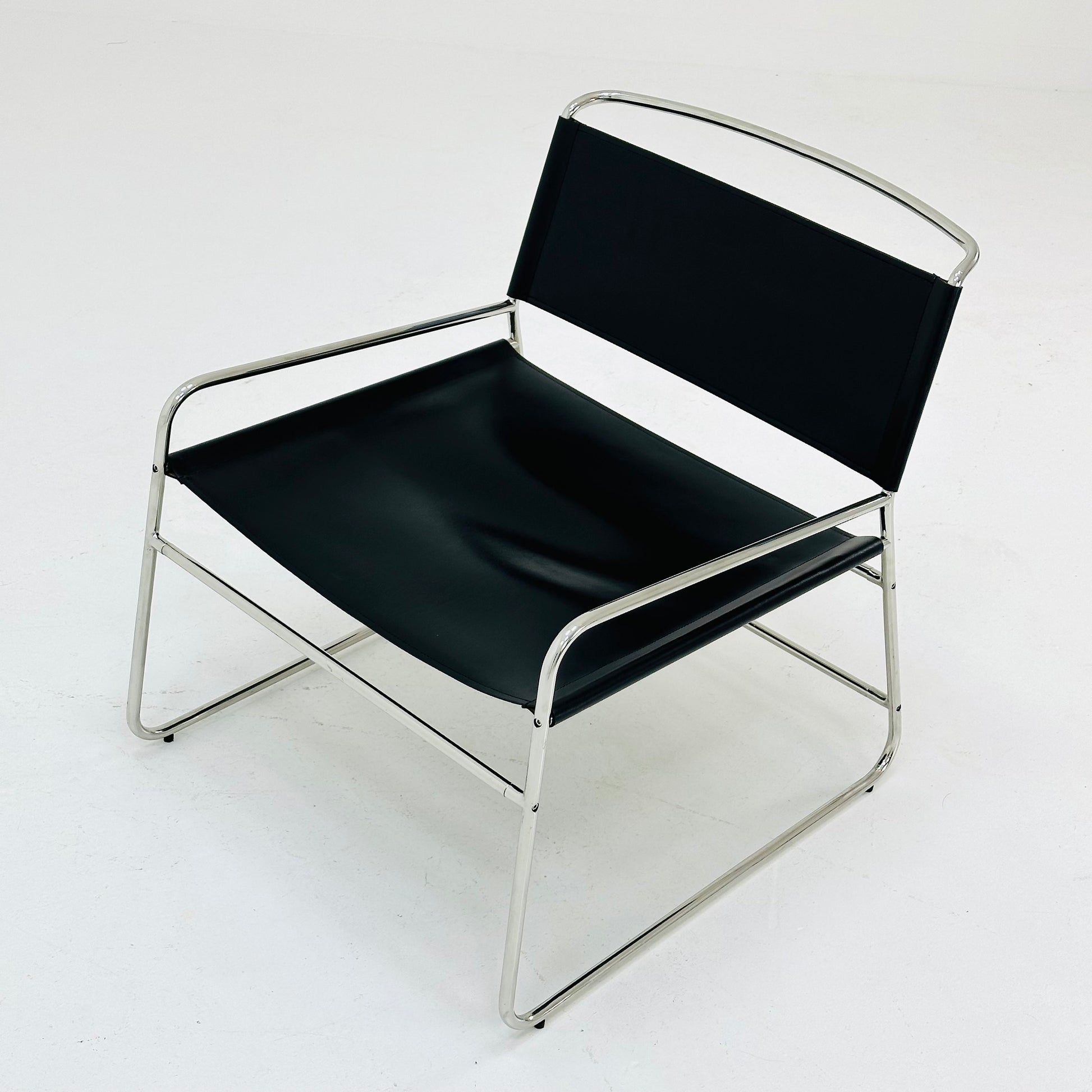 Mid century black leather lounge chair in Bauhaus style .