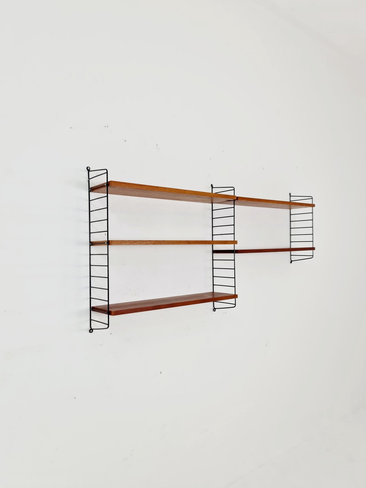 Original MCM Teak shelving system - consists of black lacquered metal ladders, from string Stockholm 1960s