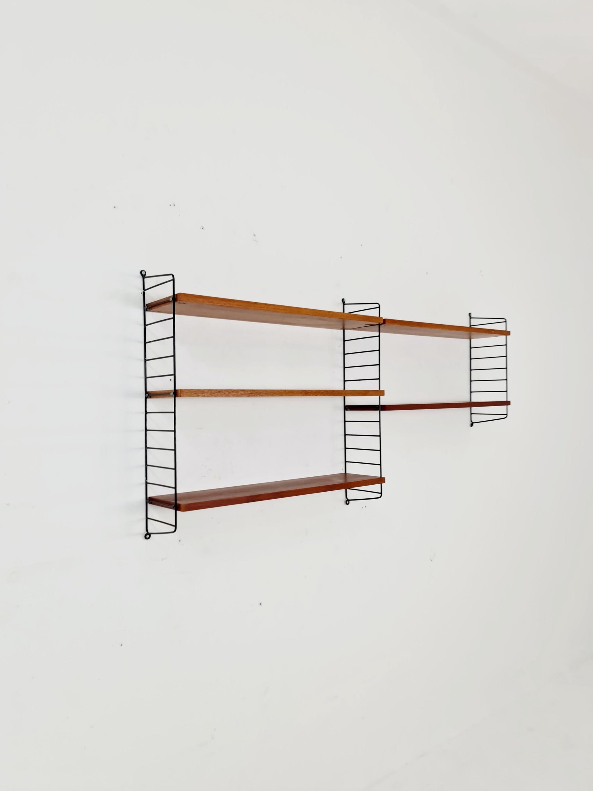 Original MCM Teak shelving system - consists of black lacquered metal ladders, from string Stockholm 1960s