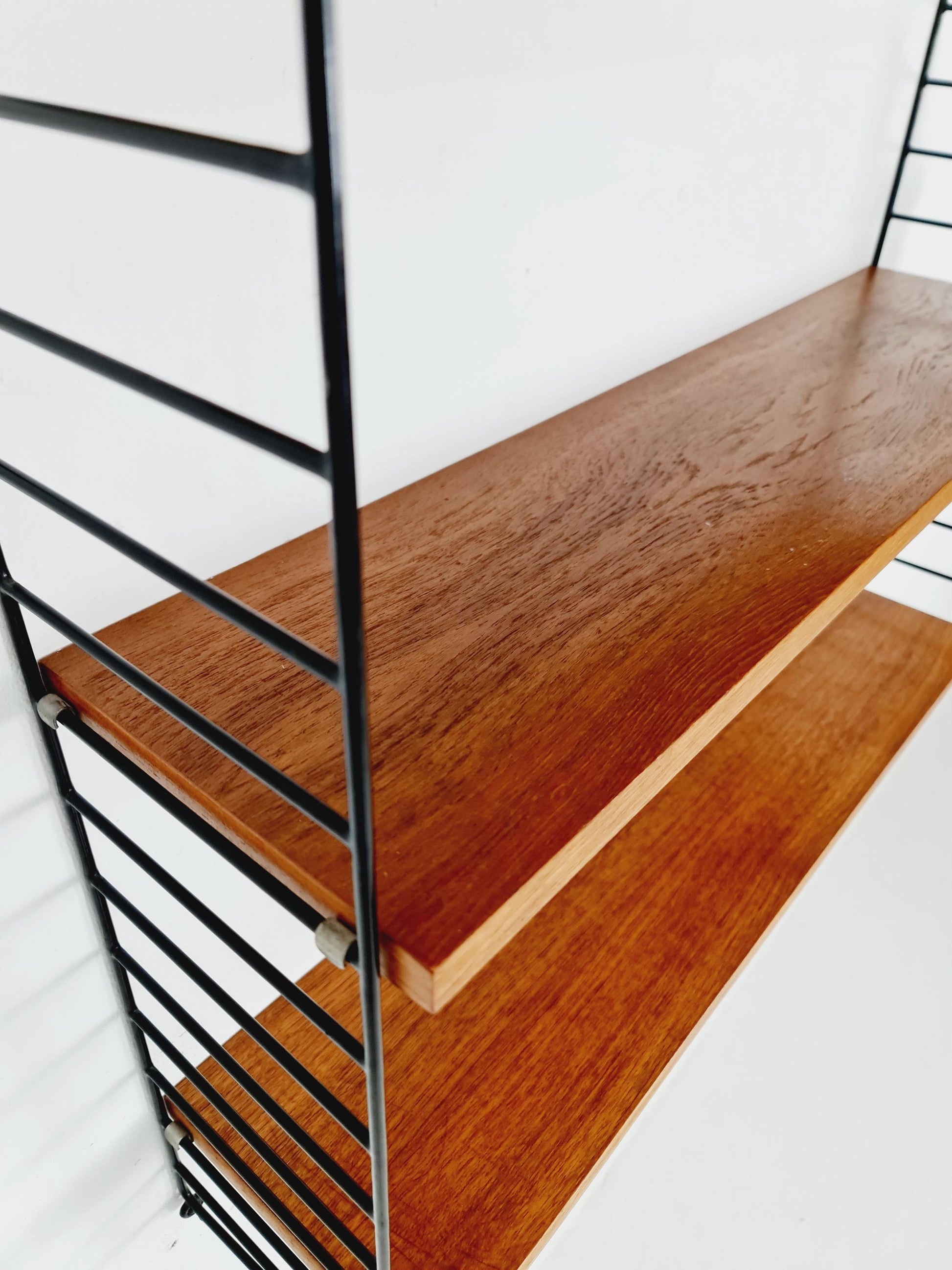 Original MCM Teak shelving system - consists of black lacquered metal ladders, from string Stockholm 1960s