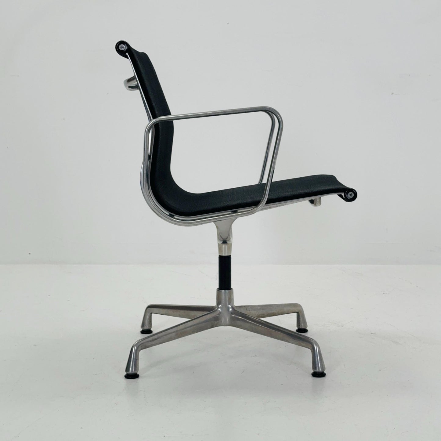 Mid century Eames EA 108 office chair by Vitra with black mesh and polished aluminum 1960s