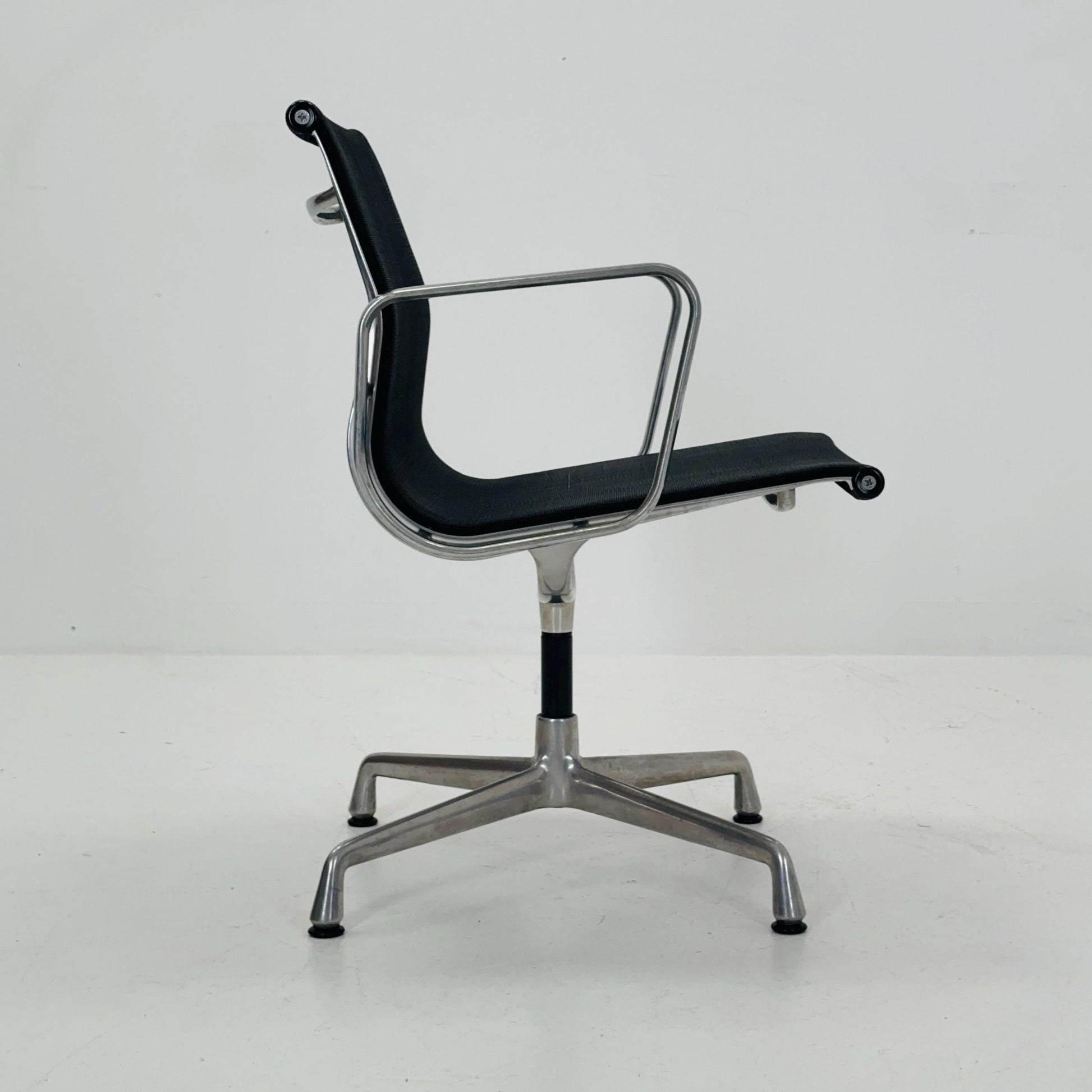 Mid century Eames EA 108 office chair by Vitra with black mesh and polished aluminum 1960s
