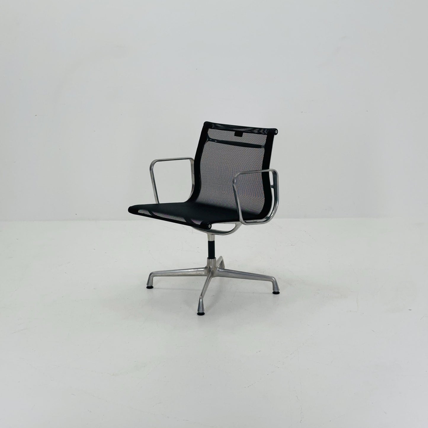 Mid century Eames EA 108 office chair by Vitra with black mesh and polished aluminum 1960s