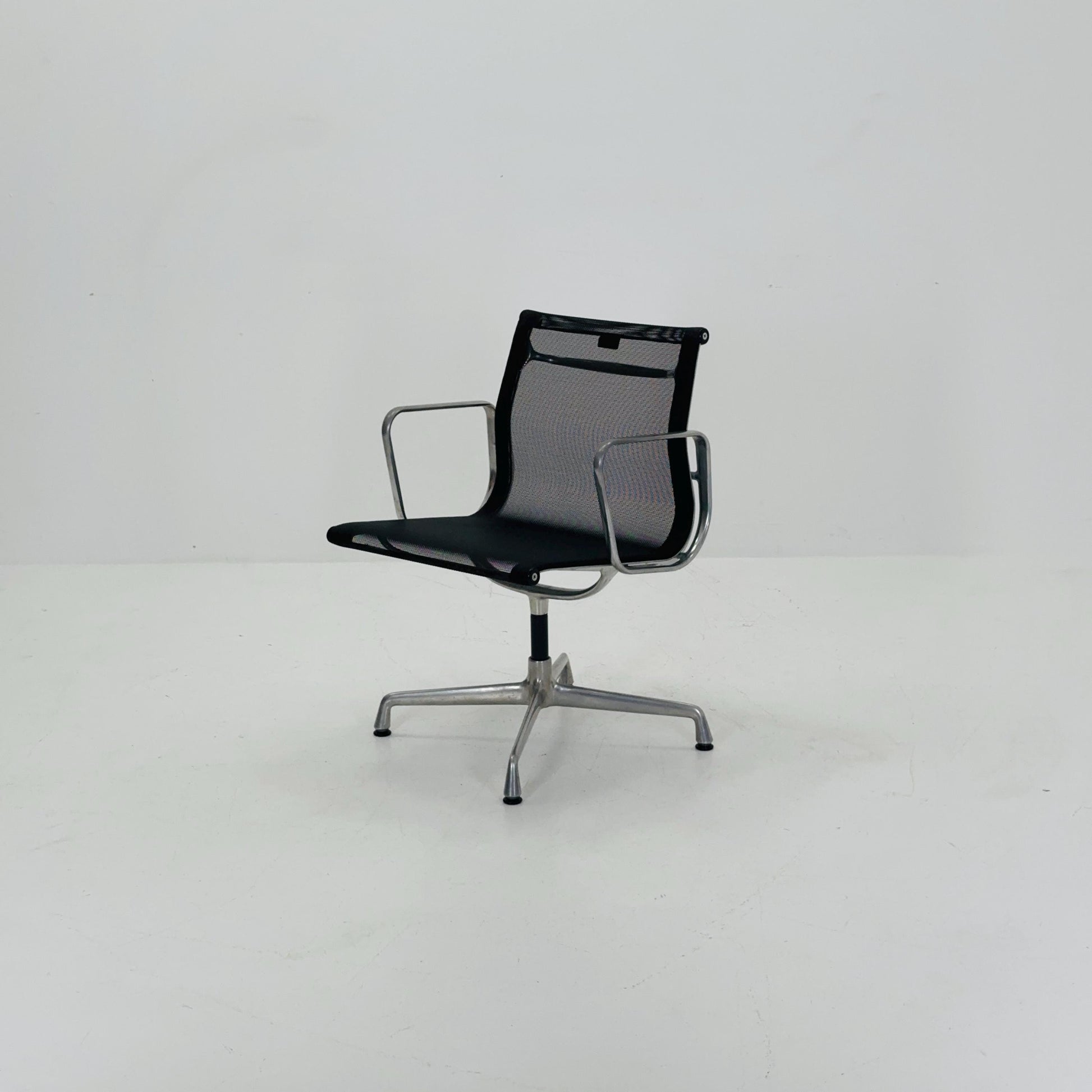 Mid century Eames EA 108 office chair by Vitra with black mesh and polished aluminum 1960s