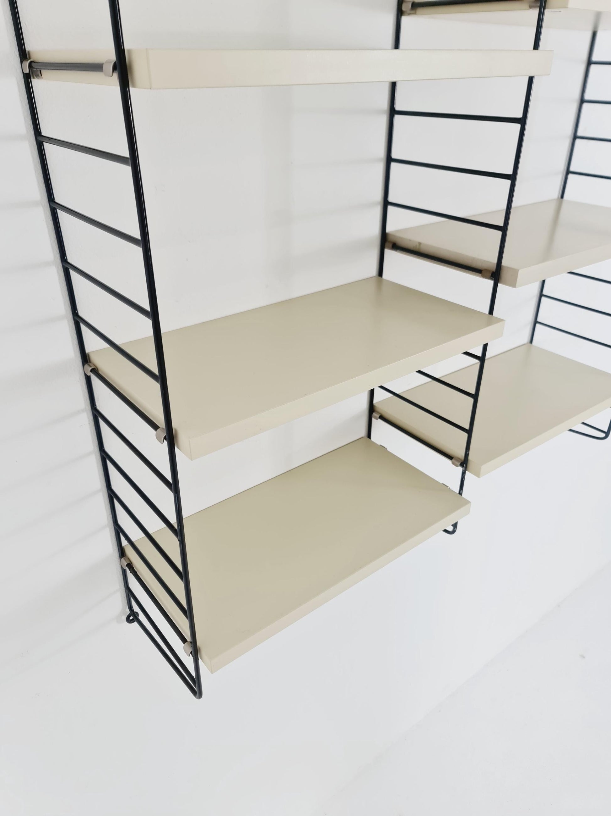 Original MCM wood shelving system - consists of black lacquered metal ladders, from string Stockholm 1960s