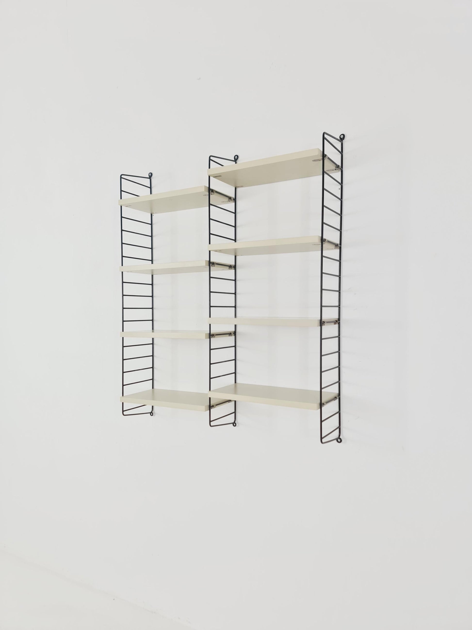 Original MCM wood shelving system - consists of black lacquered metal ladders, from string Stockholm 1960s