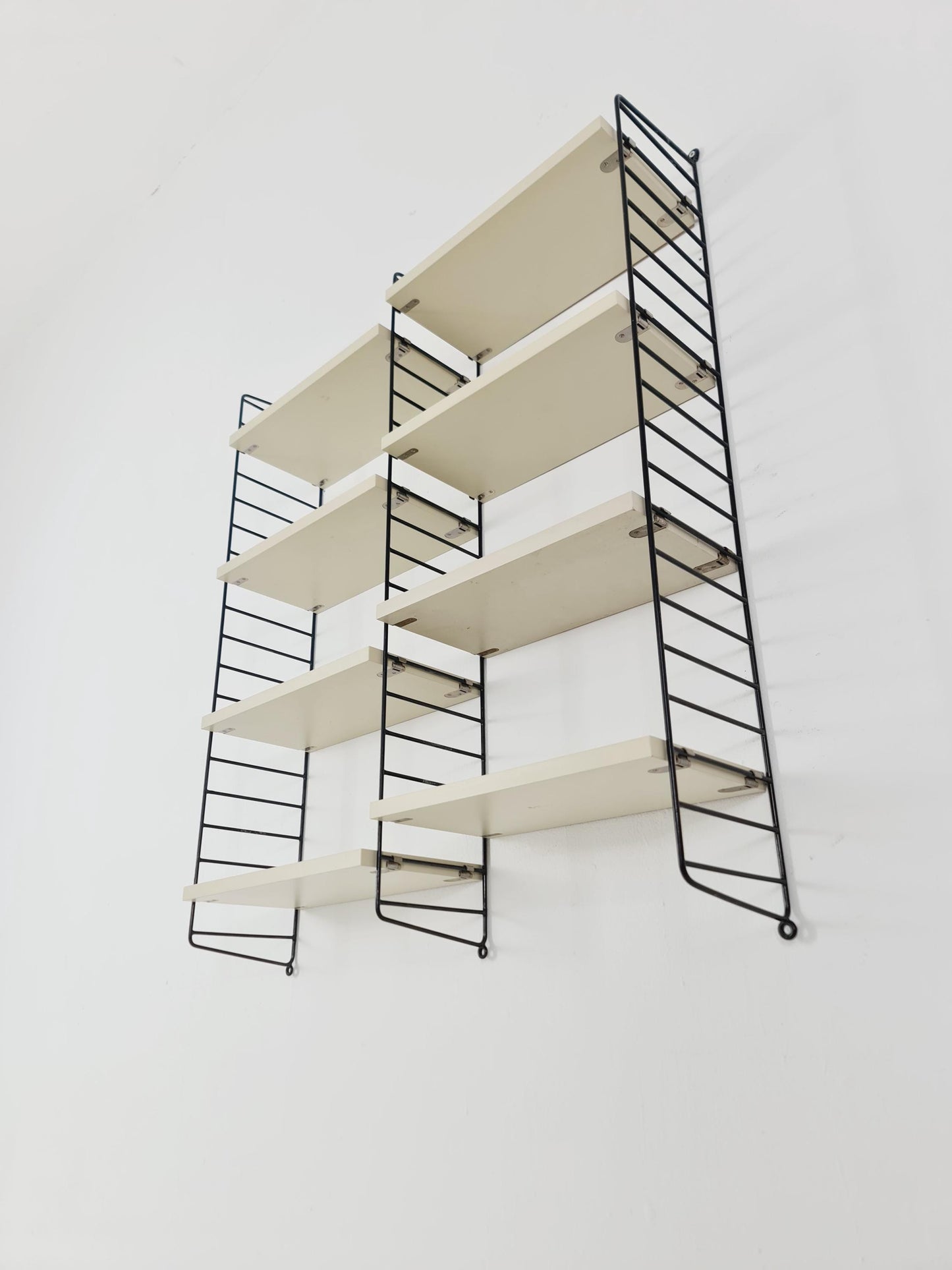 Original MCM wood shelving system - consists of black lacquered metal ladders, from string Stockholm 1960s
