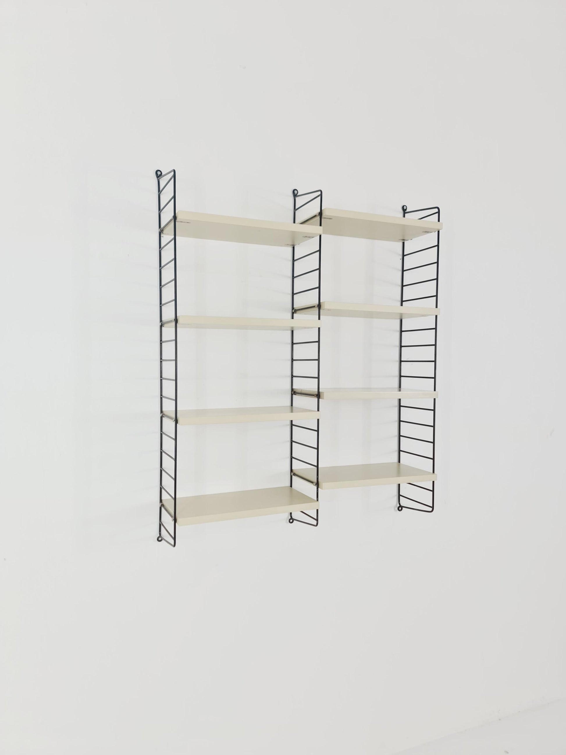 Original MCM wood shelving system - consists of black lacquered metal ladders, from string Stockholm 1960s