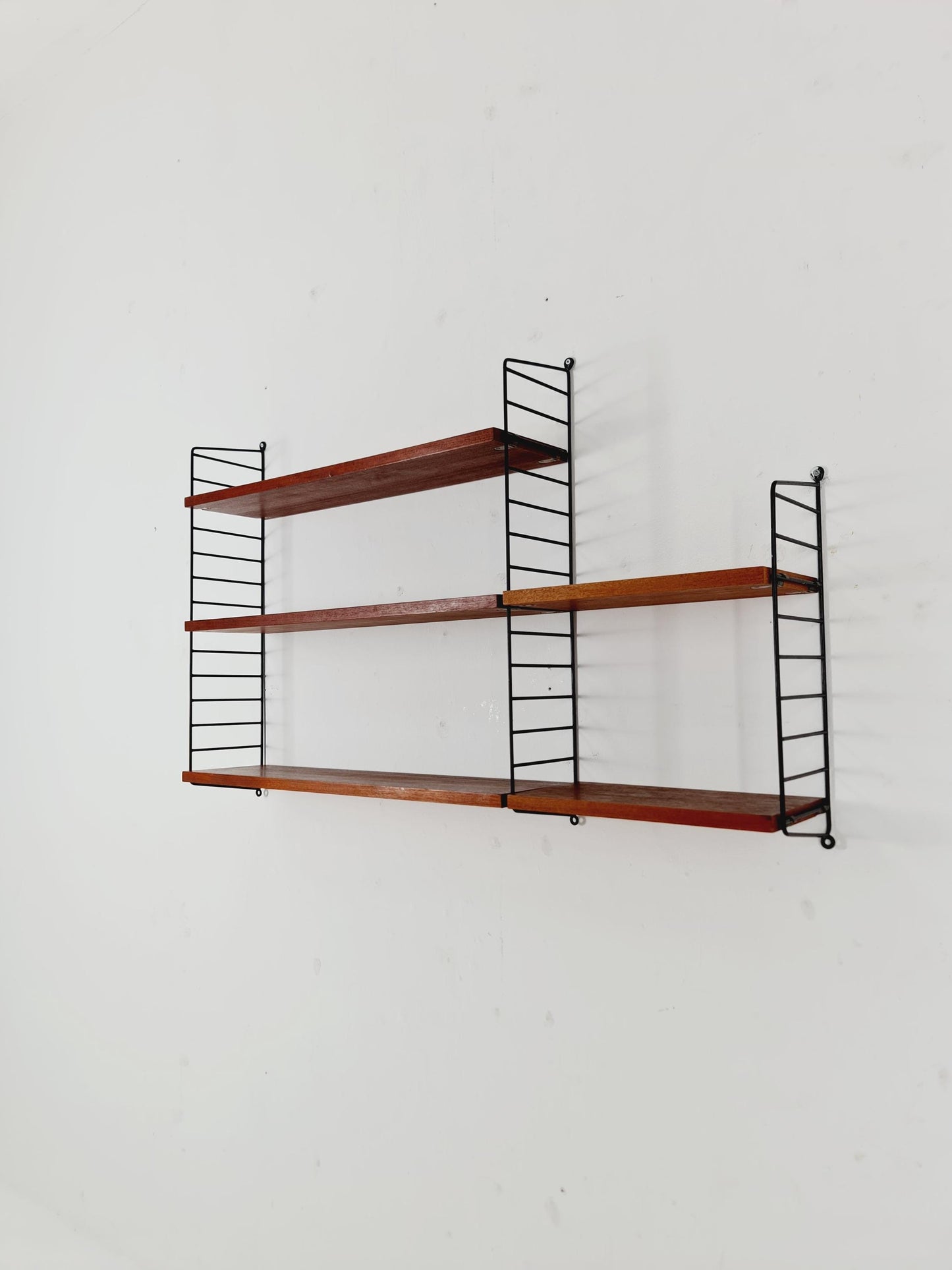 Original MCM Teak shelving system - consists of black lacquered metal ladders, from string Stockholm 1960s