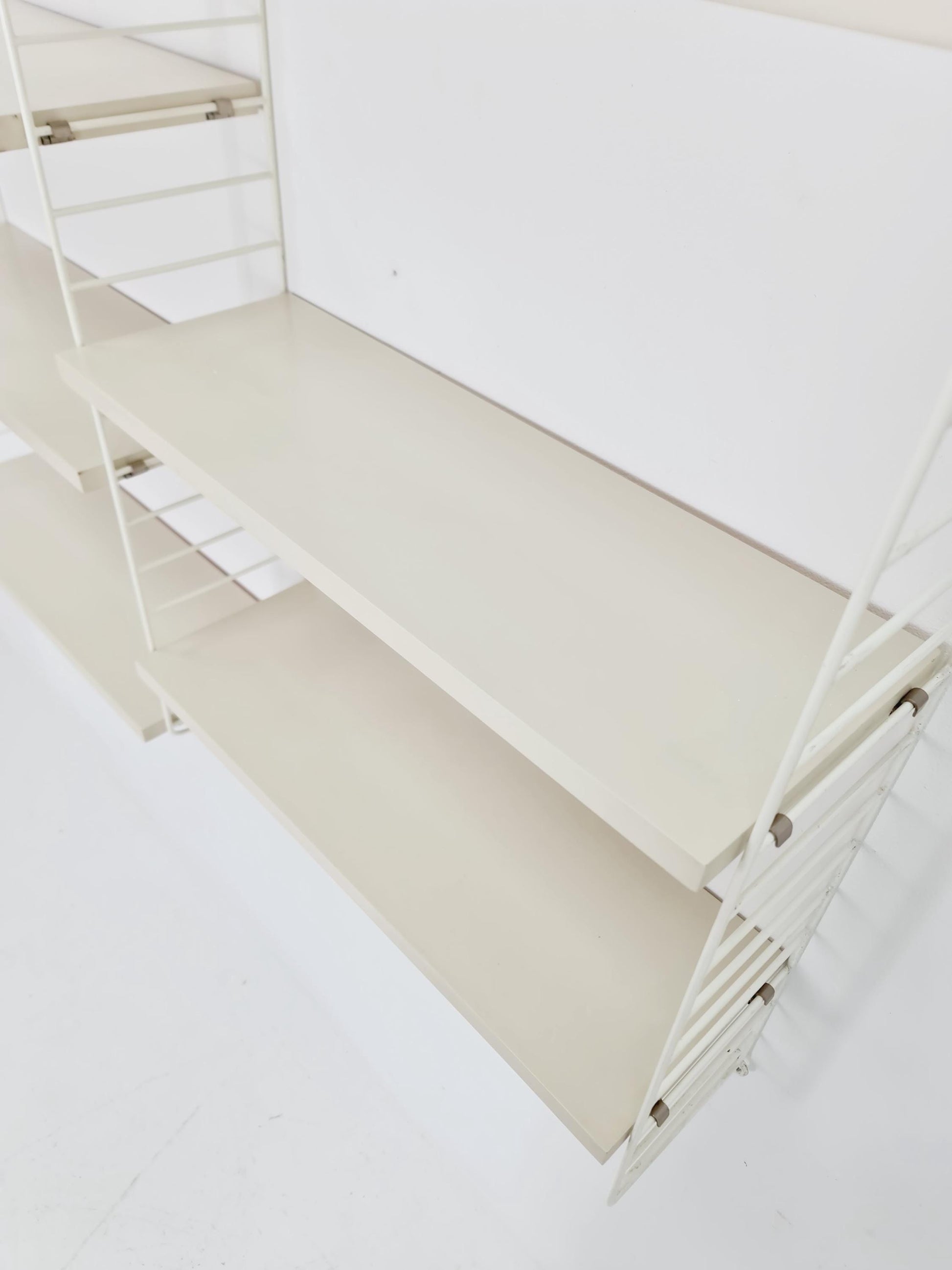 Original MCM wood shelving system - consists of black lacquered metal ladders, from string Stockholm 1960s