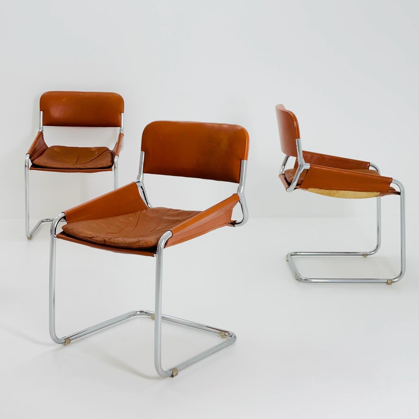 Set of 4 Mid century cognac leather & chrome tubular sling chair, Italy 1970