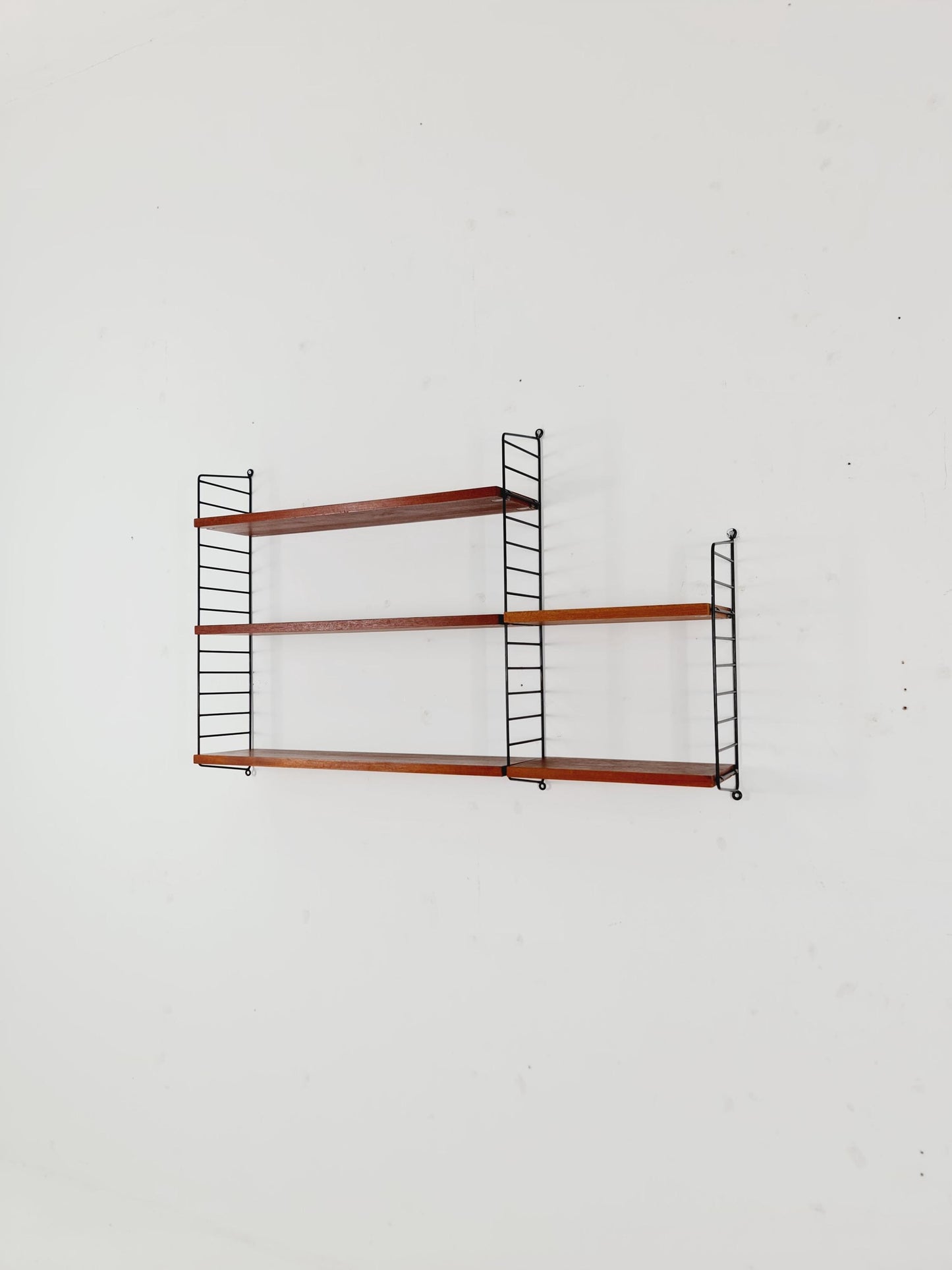 Original MCM Teak shelving system - consists of black lacquered metal ladders, from string Stockholm 1960s