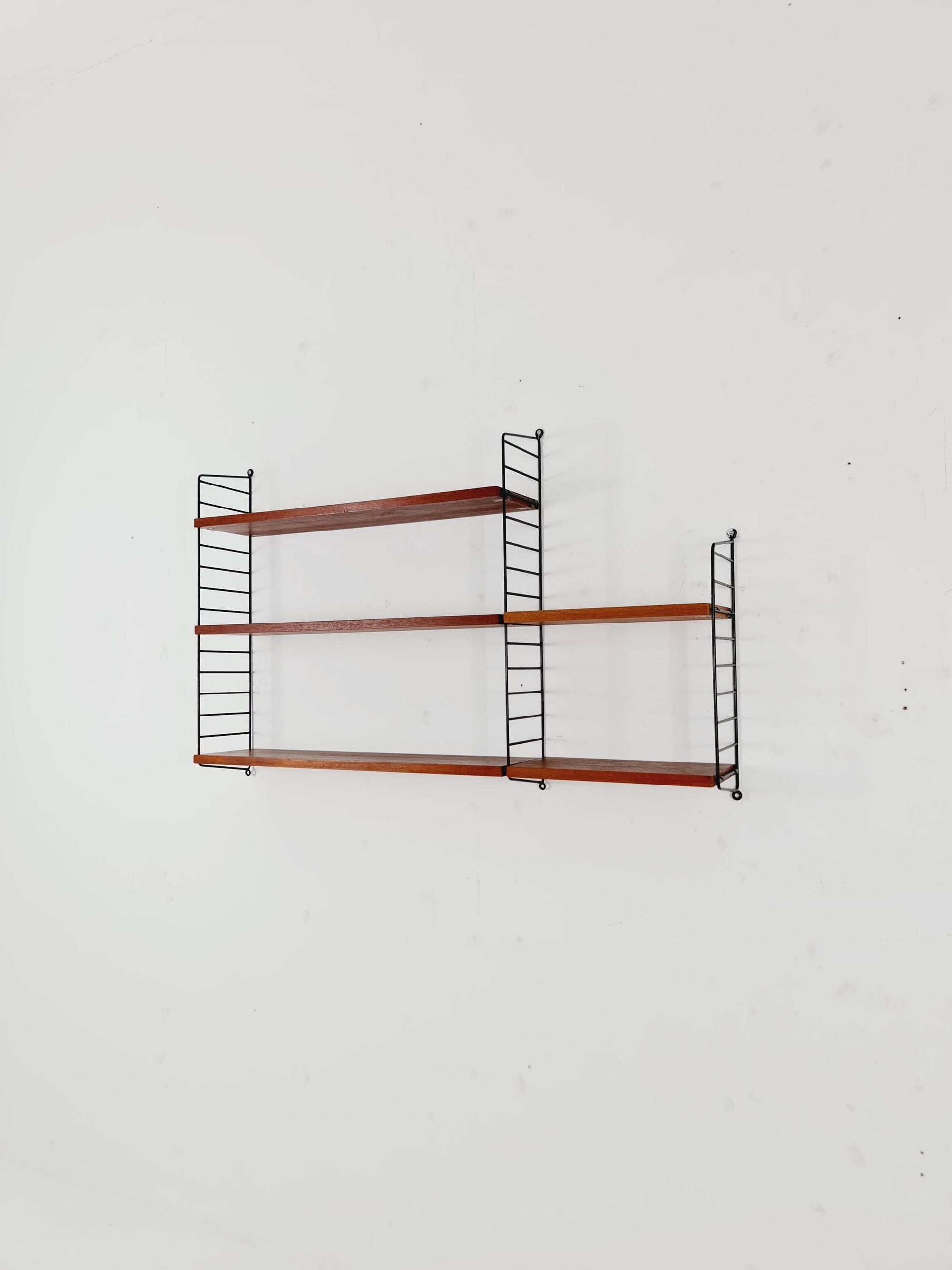 Original MCM Teak shelving system - consists of black lacquered metal ladders, from string Stockholm 1960s