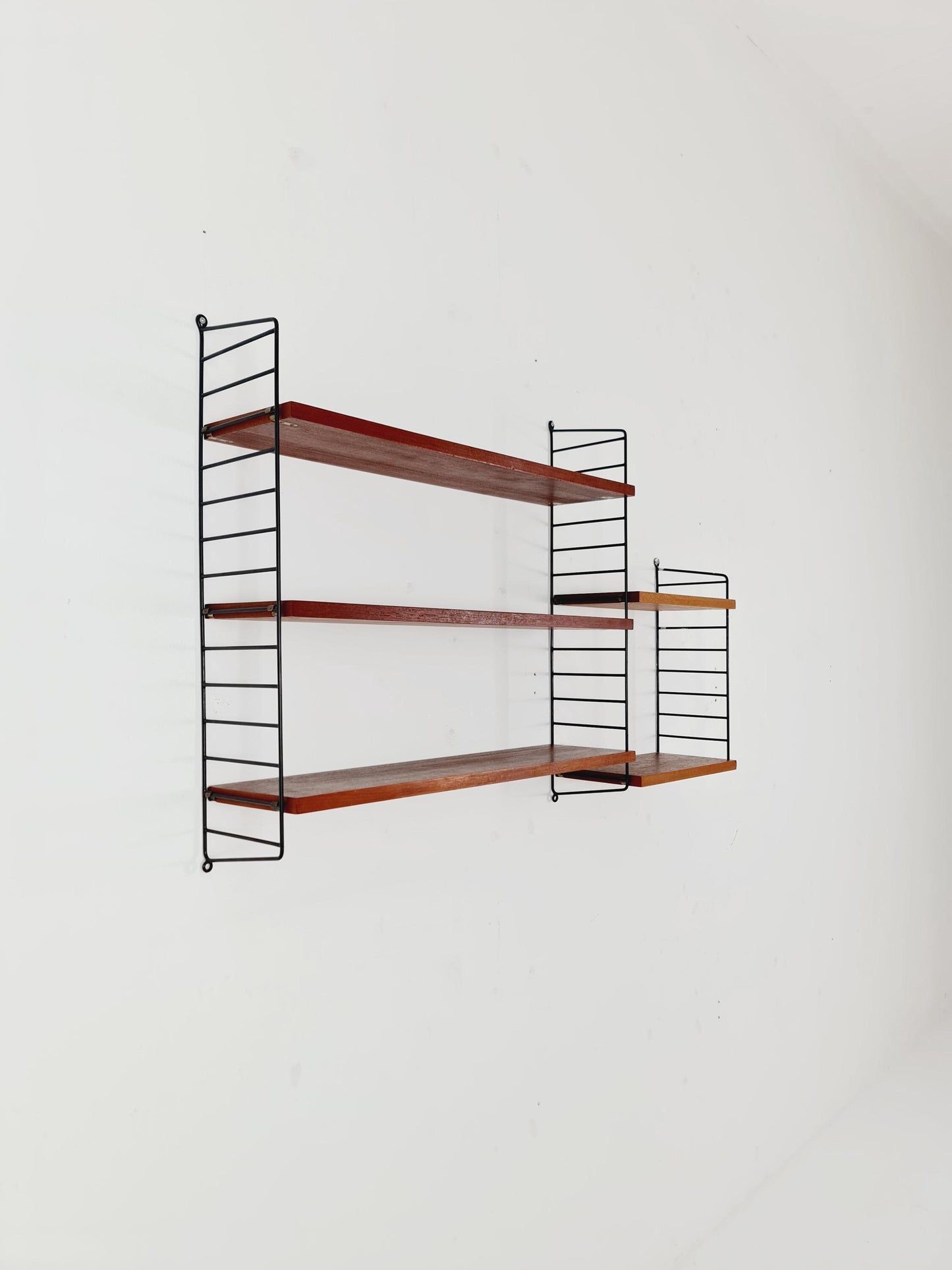 Original MCM Teak shelving system - consists of black lacquered metal ladders, from string Stockholm 1960s